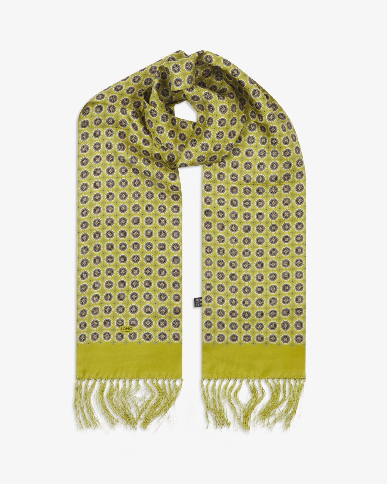 The 'Bellingham Lime' silk aviator scarf looped with both ends parallel to effectively display the full intricate geometric circular pattern against the sheen of the fine silk material.