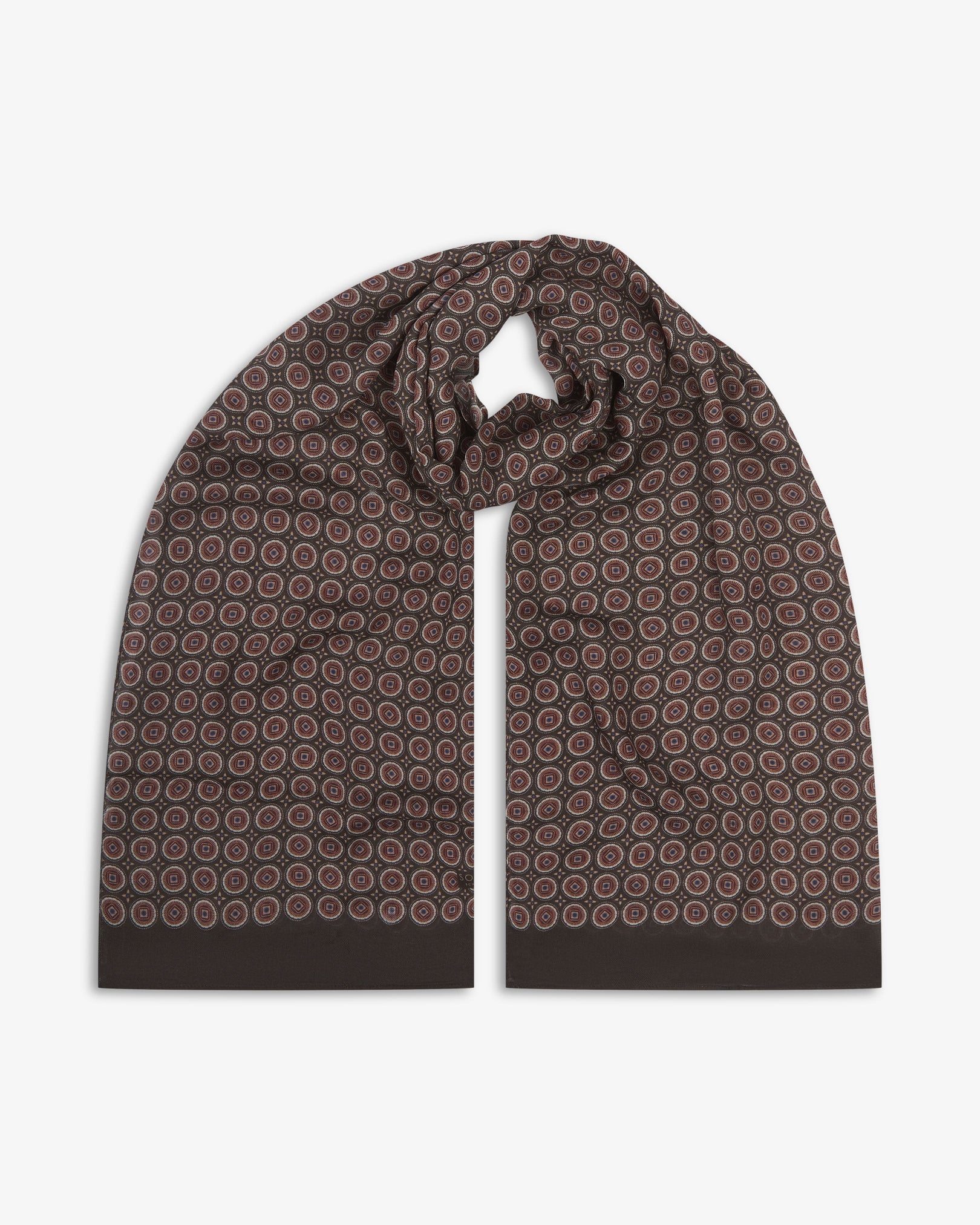 The Bellingham 'Mahogany Daze' bohemian wide scarf looped with both ends parallel, showcasing intricate concentric circular motifs in cream, maroon and subtle purple on a rich brown background across the soft modal and wool blend fabric.