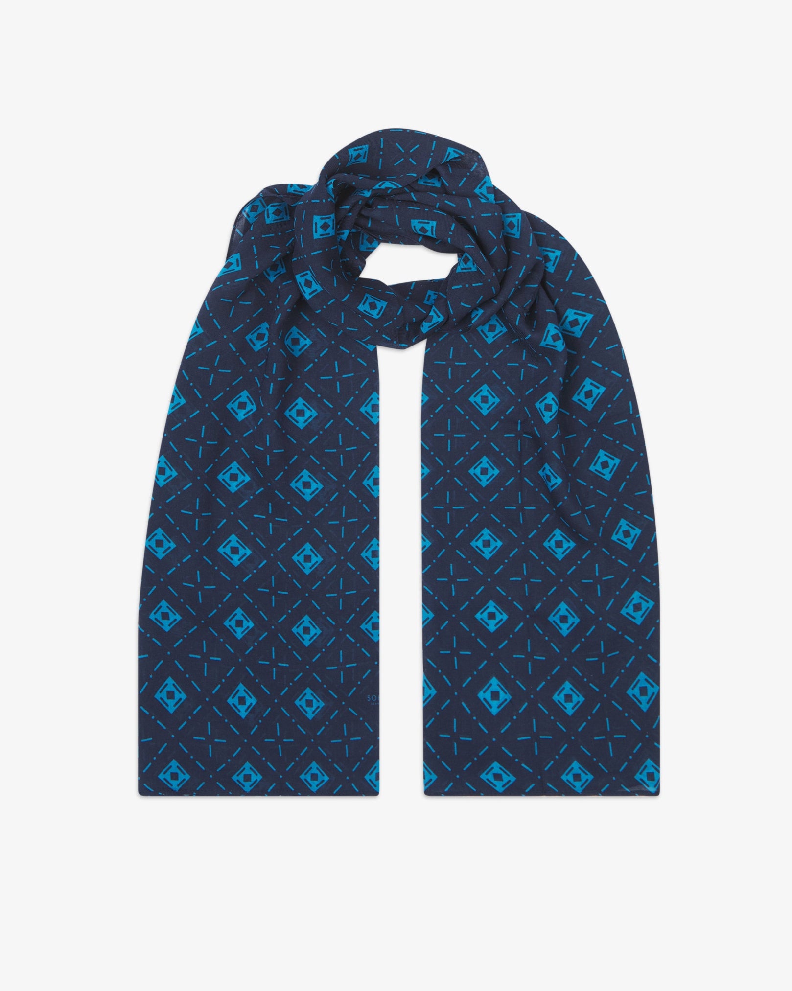 The 'Diamonds' blue bohemian wide scarf looped with both ends parallel, showcasing an ordered diamond mosaic of light blue lozenges and crosshair motifs on a navy blue background across the soft modal and wool blend fabric.