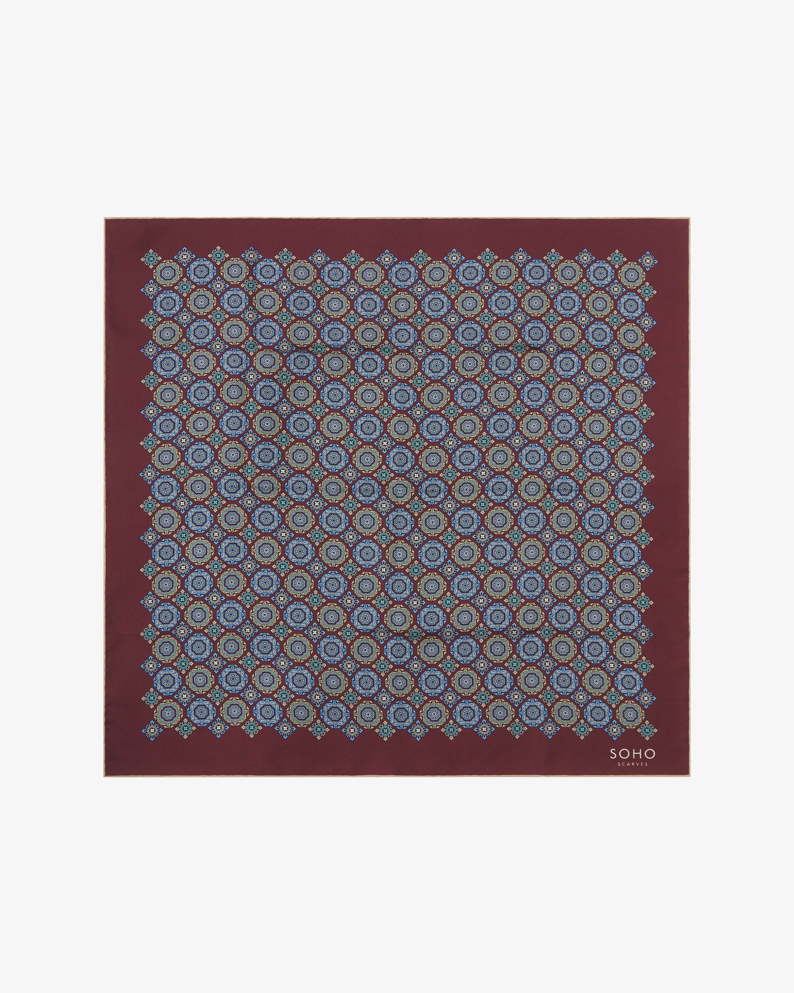 Fully unfolded 'Fitzrovia' silk neckerchief, clearly displaying the symmetrical medallion layout in blue, green, and beige tones across a burgundy base, framed with a fine golden-beige edge.