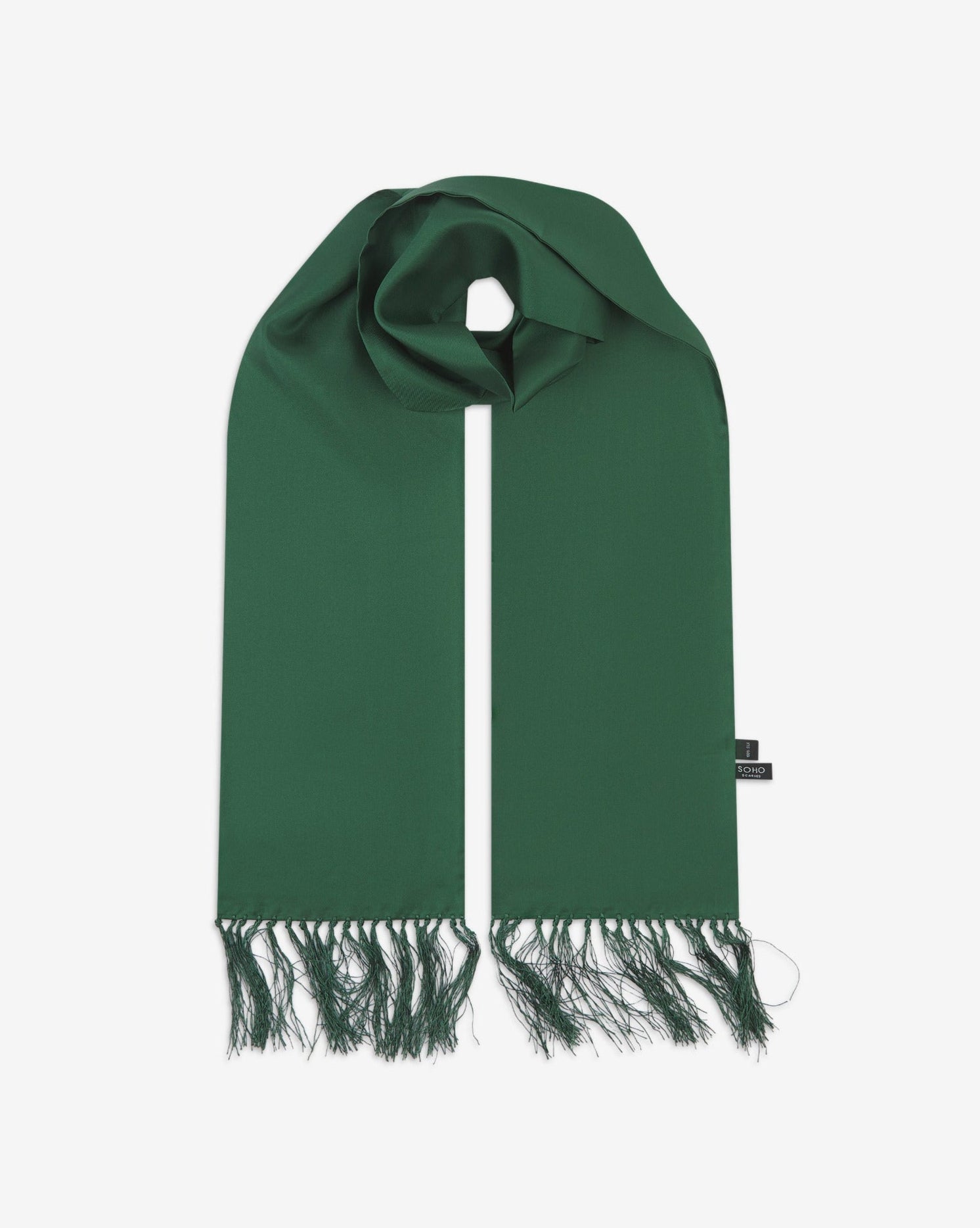 Green silk aviator scarf from Soho Scarves. Looped with both ends parallel showing the branding label to the right and the matching 8cm long fringes.