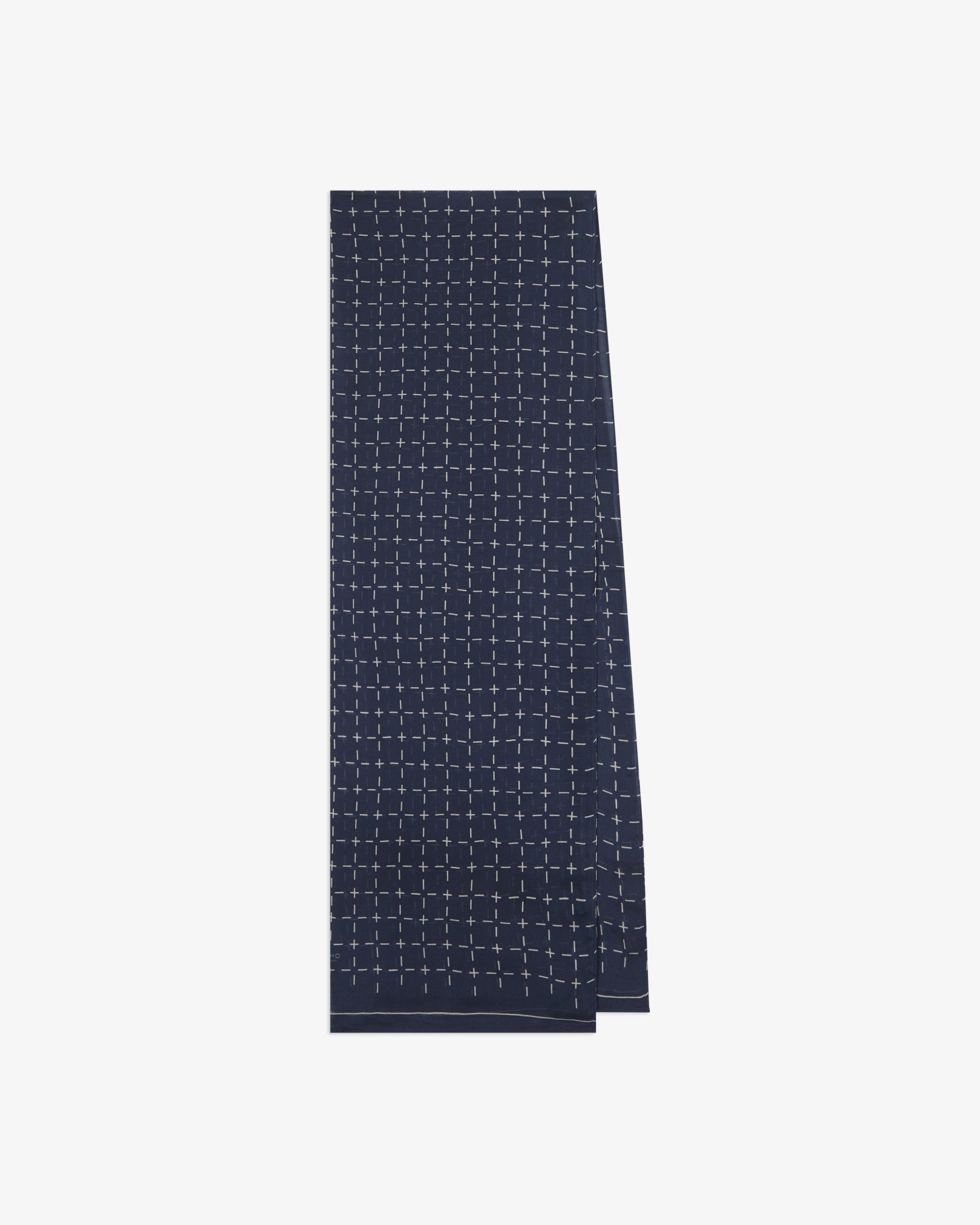 The 'Crosses' indigo bohemian wide scarf from SOHO Scarves folded and presented vertically to show the full dimensions and repeating geometric grid pattern of white dashes and crosses on an indigo blue background.