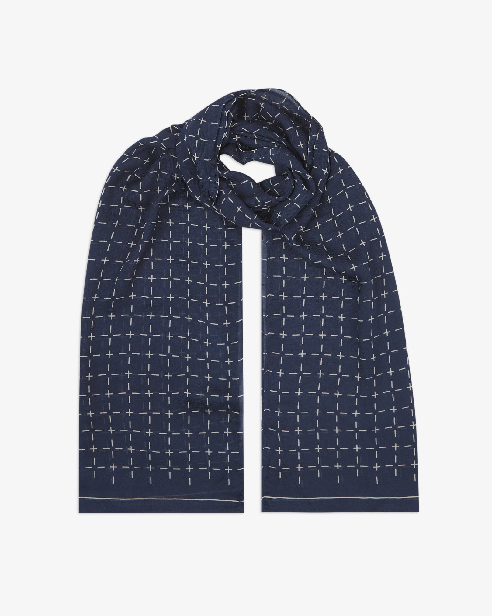 The 'Crosses' indigo bohemian wide scarf looped with both ends parallel, showcasing a neat geometric grid of white dashes and crosses on an indigo blue background across the soft modal and wool blend fabric.