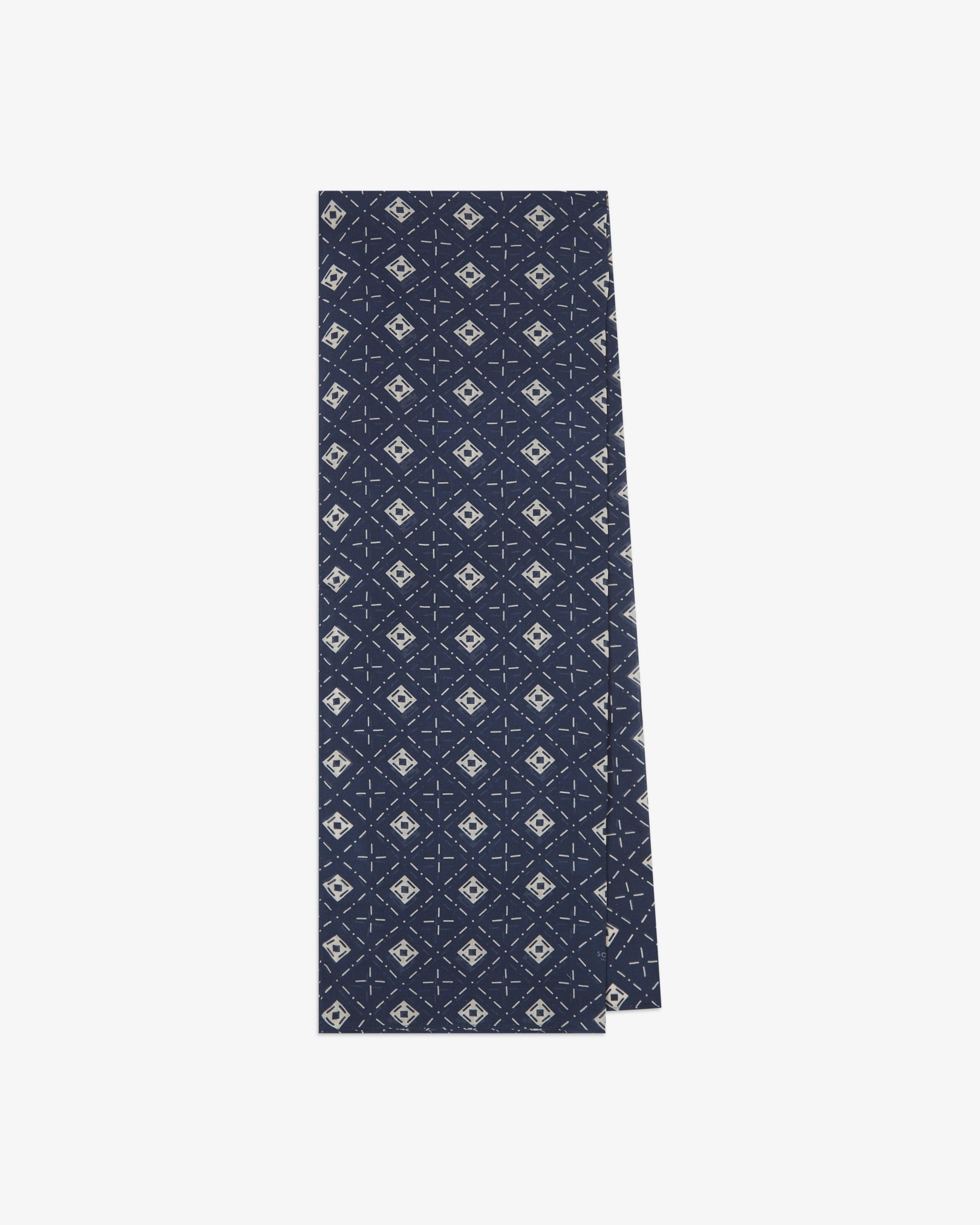 The 'Diamonds' indigo bohemian wide scarf from SOHO Scarves folded and presented vertically to show the full dimensions and repeating diamond mosaic pattern of white lozenges and crosshair motifs on an indigo blue background.