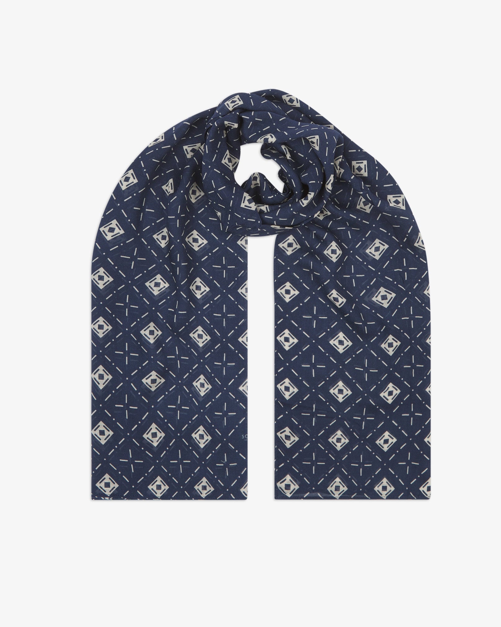The 'Diamonds' indigo bohemian wide scarf looped with both ends parallel, showcasing an ordered diamond mosaic of white lozenges and crosshair motifs on an indigo blue background across the soft modal and wool blend fabric.