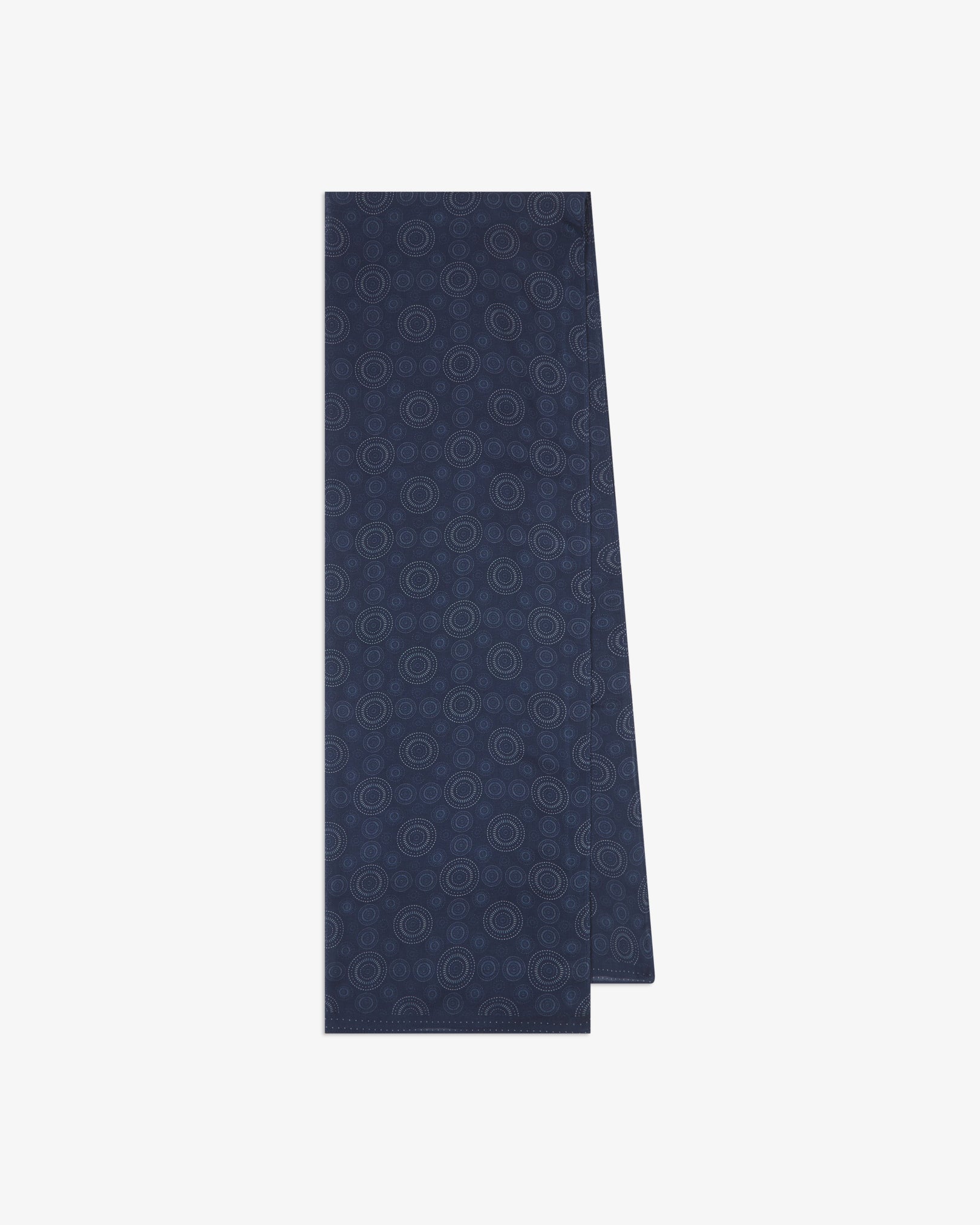 The 'Circles' indigo bohemian wide scarf folded and presented vertically to show the full dimensions and repeating concentric Op art-inspired disc pattern in white on a deep indigo-blue background.