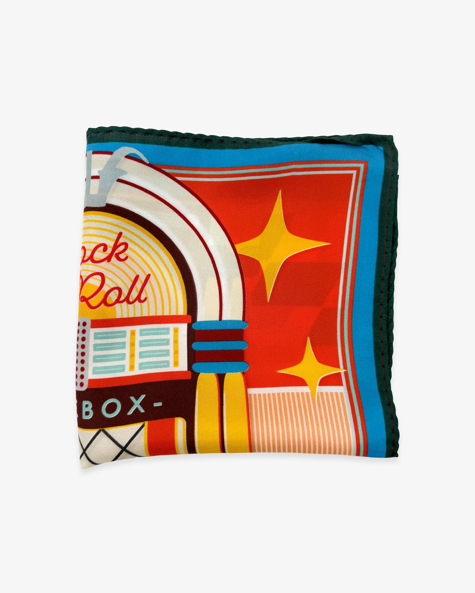 The 'Jukebox' silk pocket square from SOHO Scarves folded into a quarter, showing a portion of the iconic 1950's jukebox illustration blue and black border.