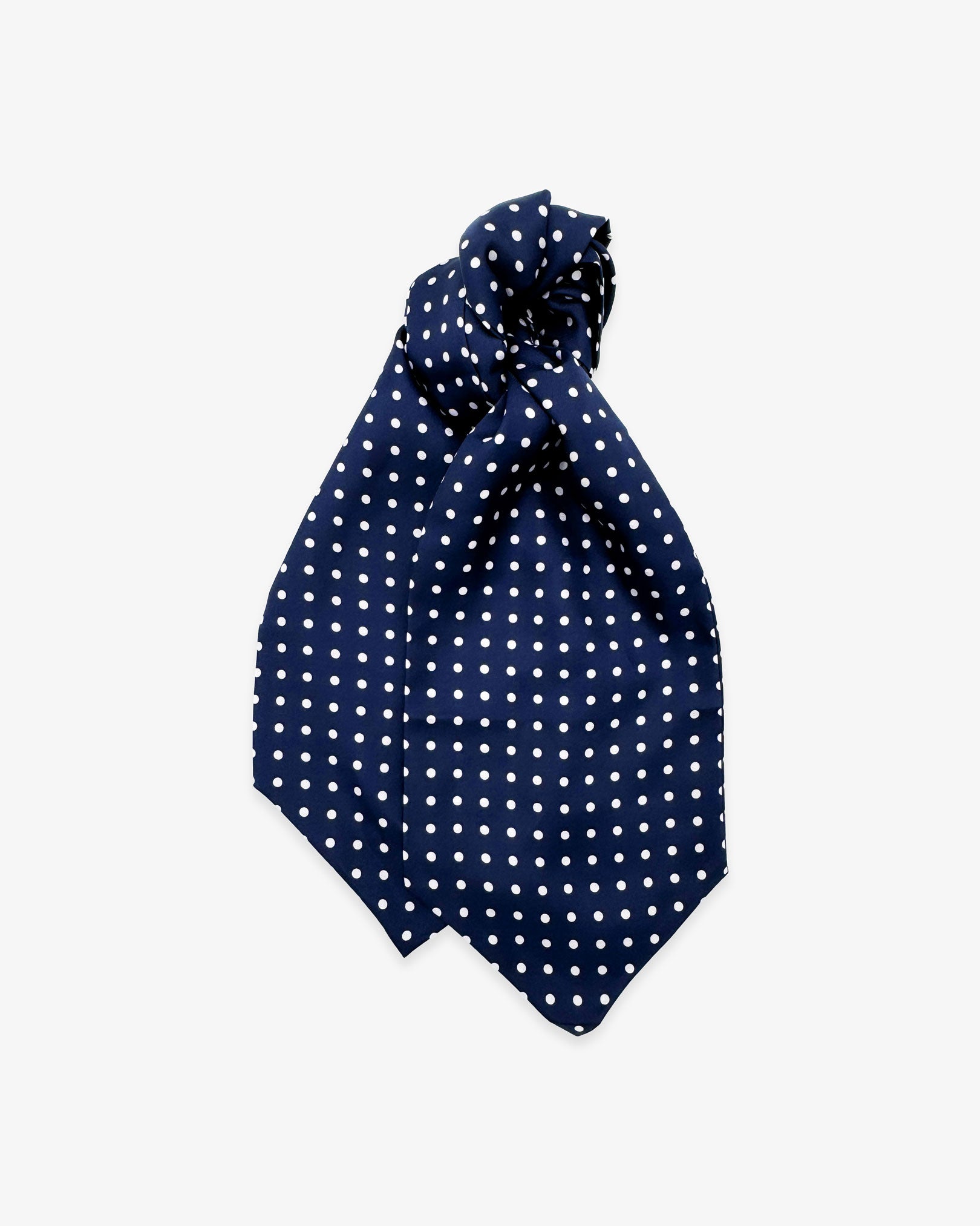 Entire view of 'The Westminster' double Ascot tie with wide ends at the bottom and clear view of the white polka dots on a navy-blue background