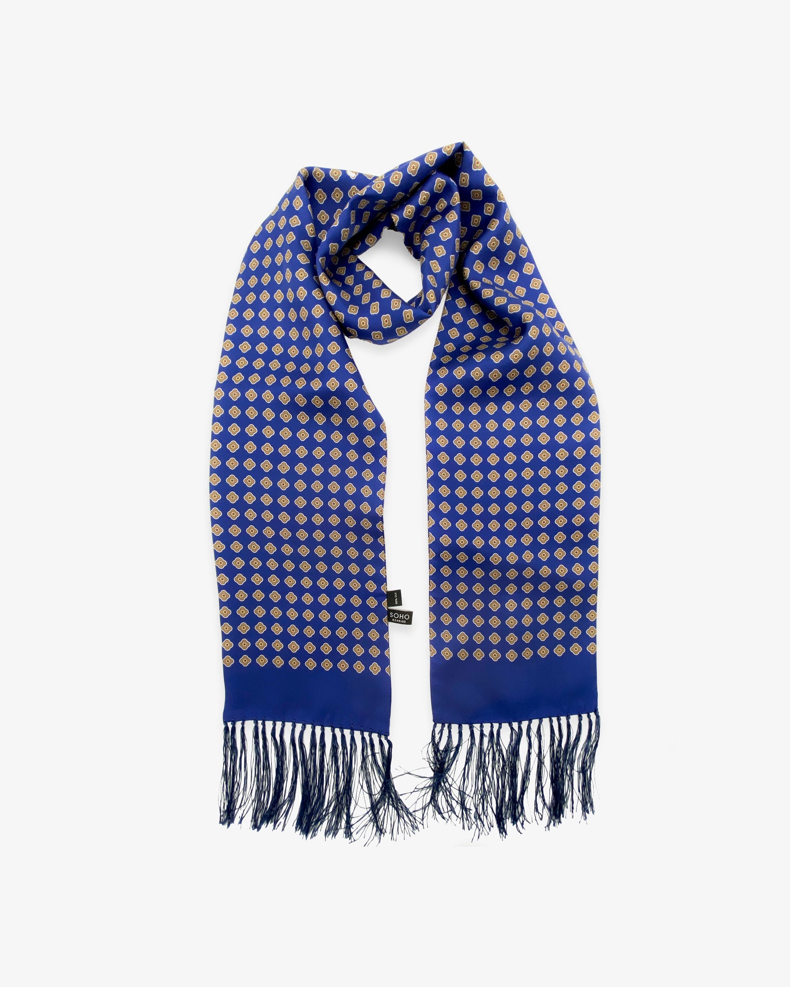 The Auburn pure silk aviator scarf looped in middle with both ends parallel showing the pink flower patterns on a blue background with matching 3-inch fringe.