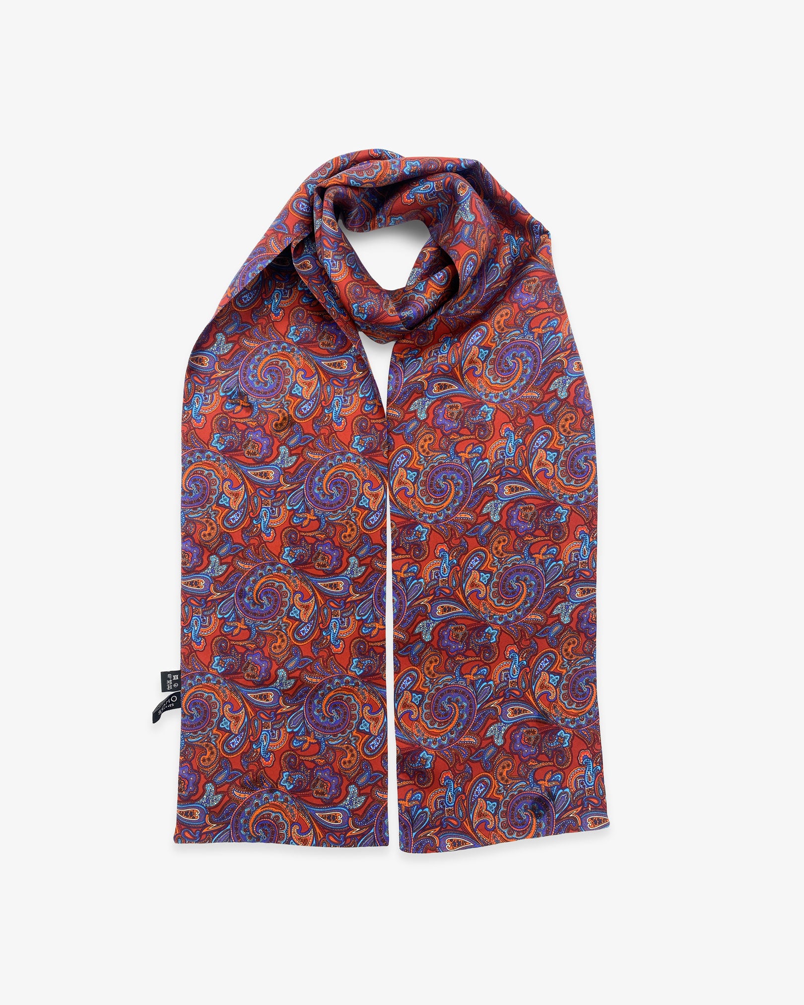 The Bretton pure silk paisley scarf looped in middle with both ends parallel showing the blue paisley patterns on a deep reddish-brown ground. 