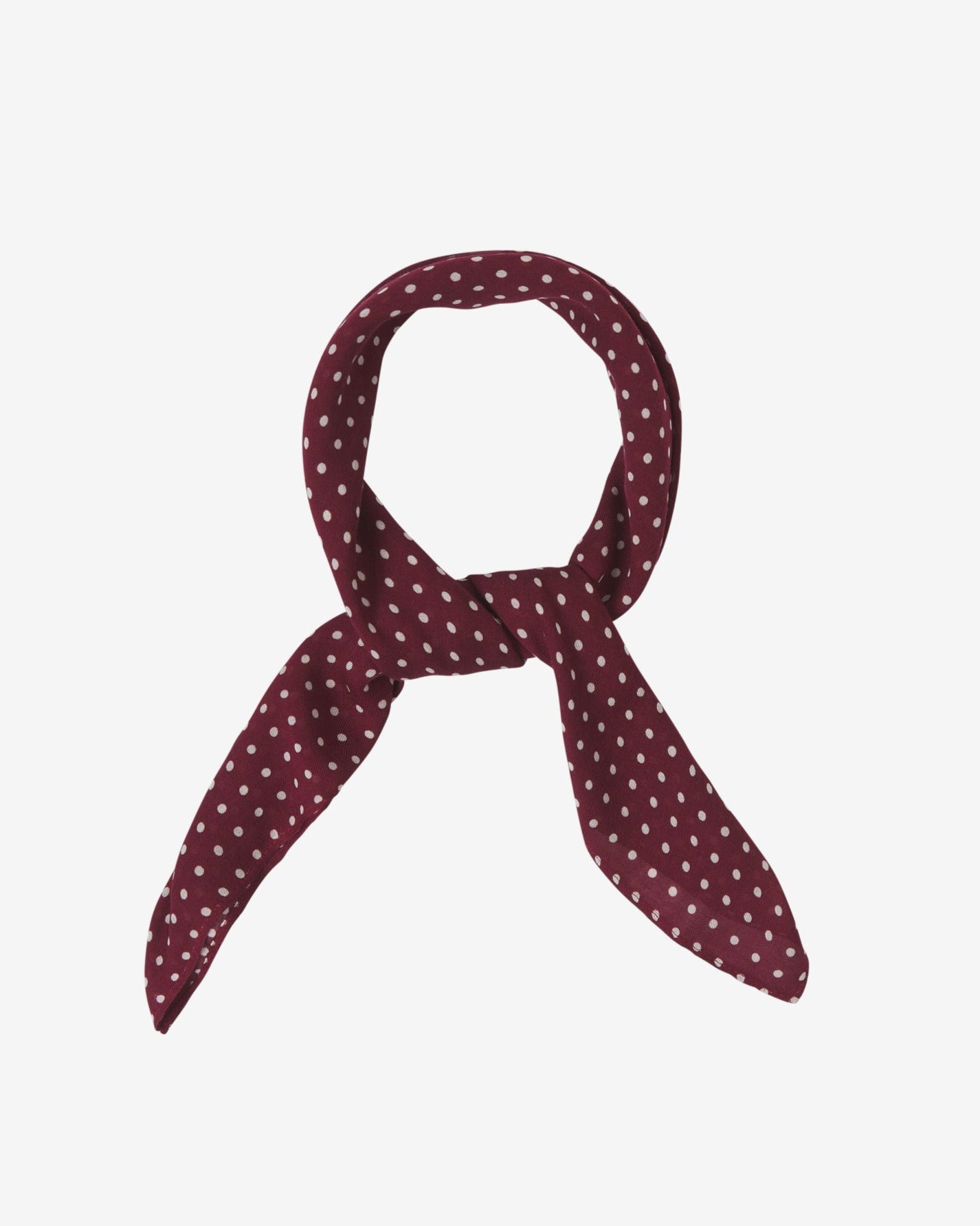 The Sapporo bandana knotted into a loop, showing the attractive white polka dot pattern against a burgundy ground.