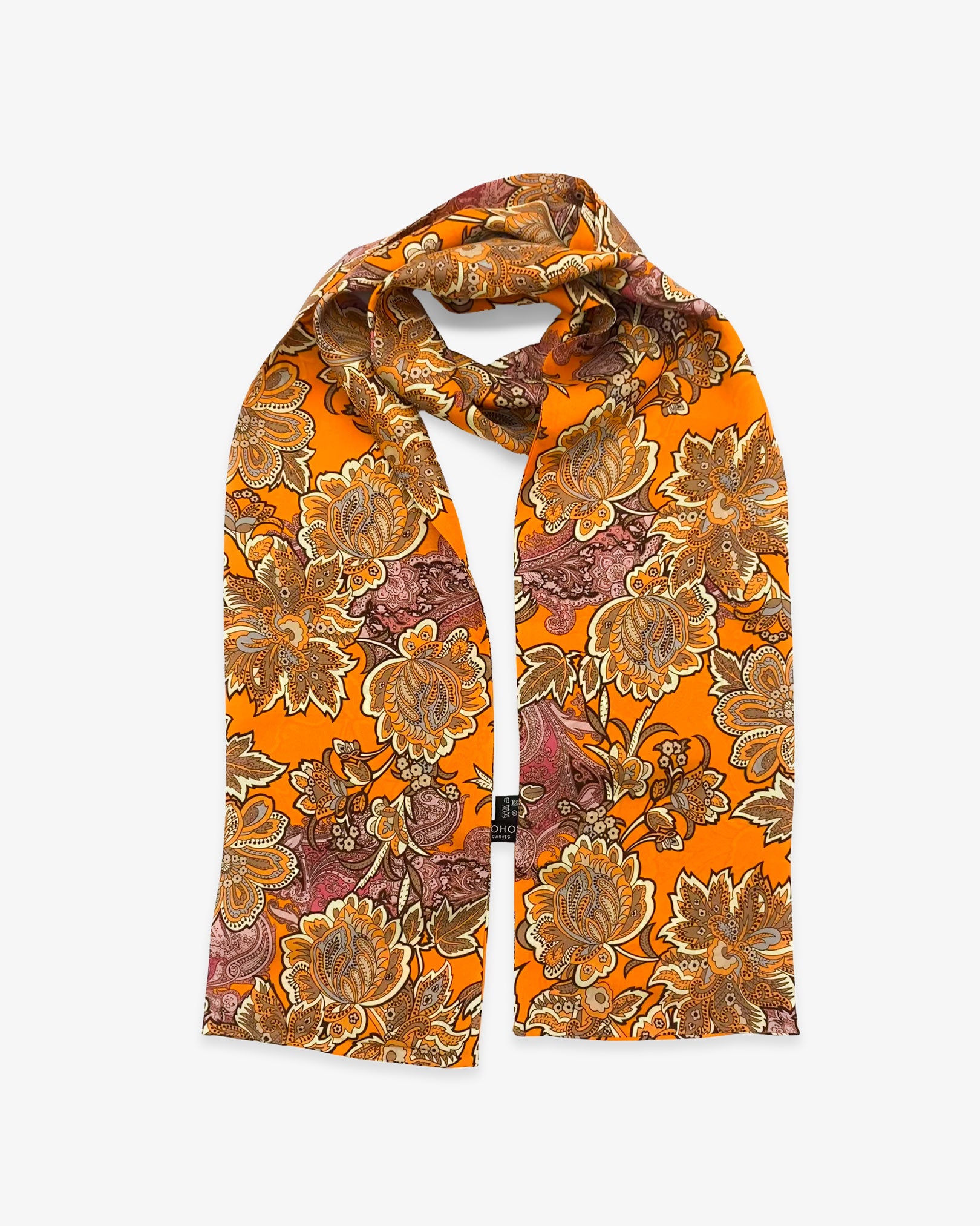 The Niagra pure silk floral scarf looped in middle with both ends parallel showing vibrant, orange background. Clearly showing the repeating pink and orange floral-paisley leaves and flowers.