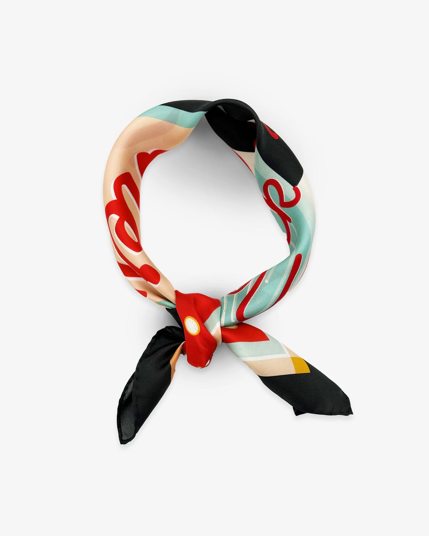 The 'Milkshake' on charcoal silk neckerchief from SOHO Scarves knotted and looped against a white background.
