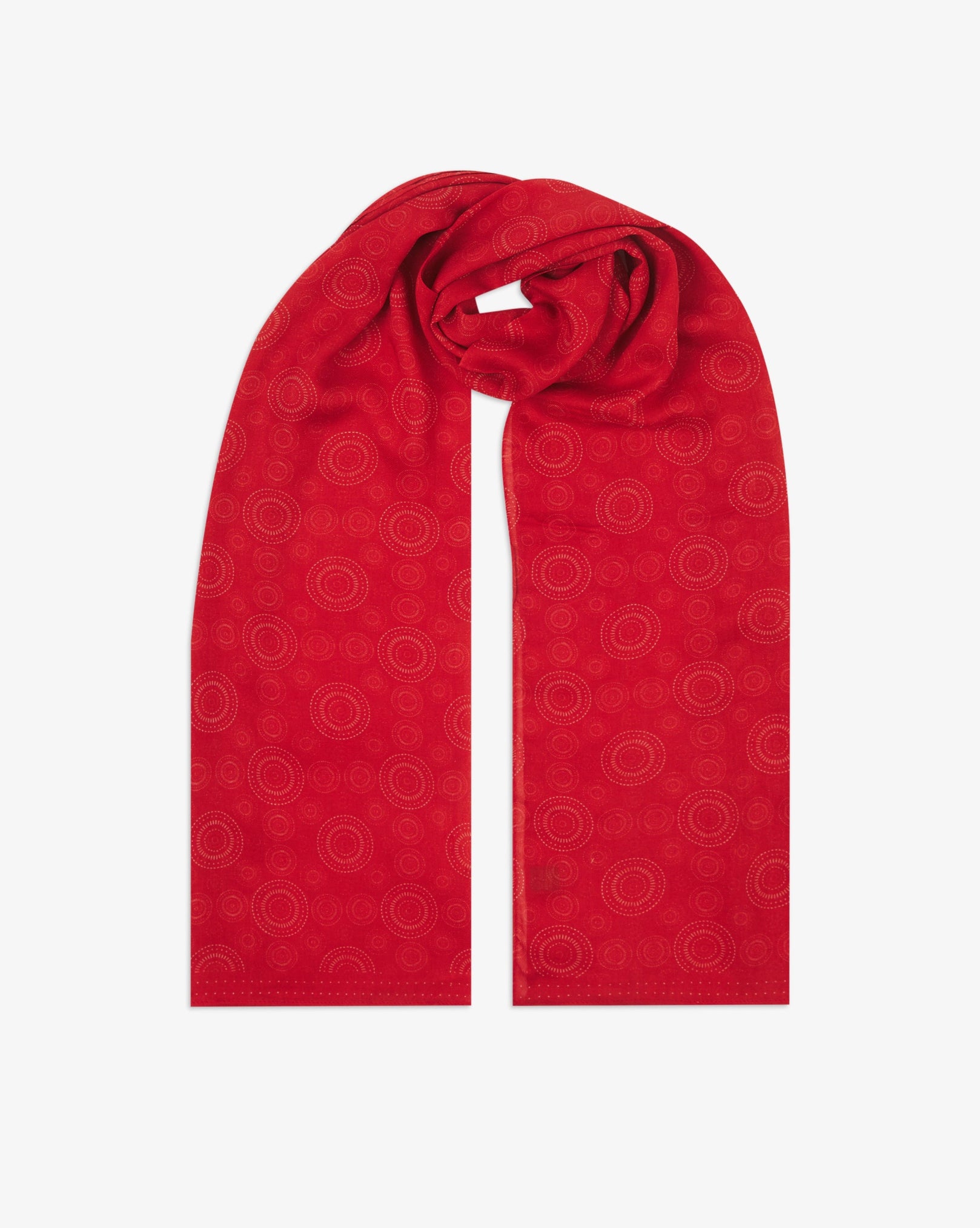 The 'Circles' red bohemian wide scarf looped with both ends parallel, showcasing concentric Op art-inspired disc motifs in white on a bright red background across the soft modal and wool blend fabric.