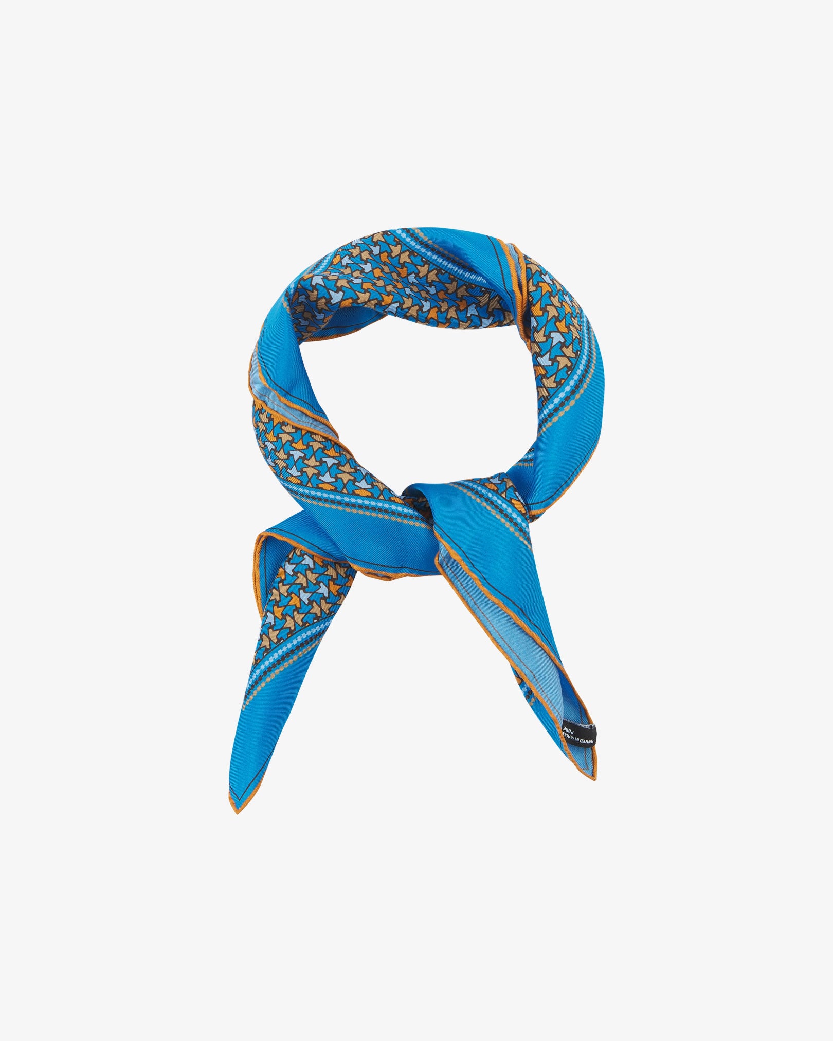 The 'Richmond' neckerchief looped and knotted, featuring vivid azure silk bordered with a tessellated leaf pattern in orange, gold, and sky blue.