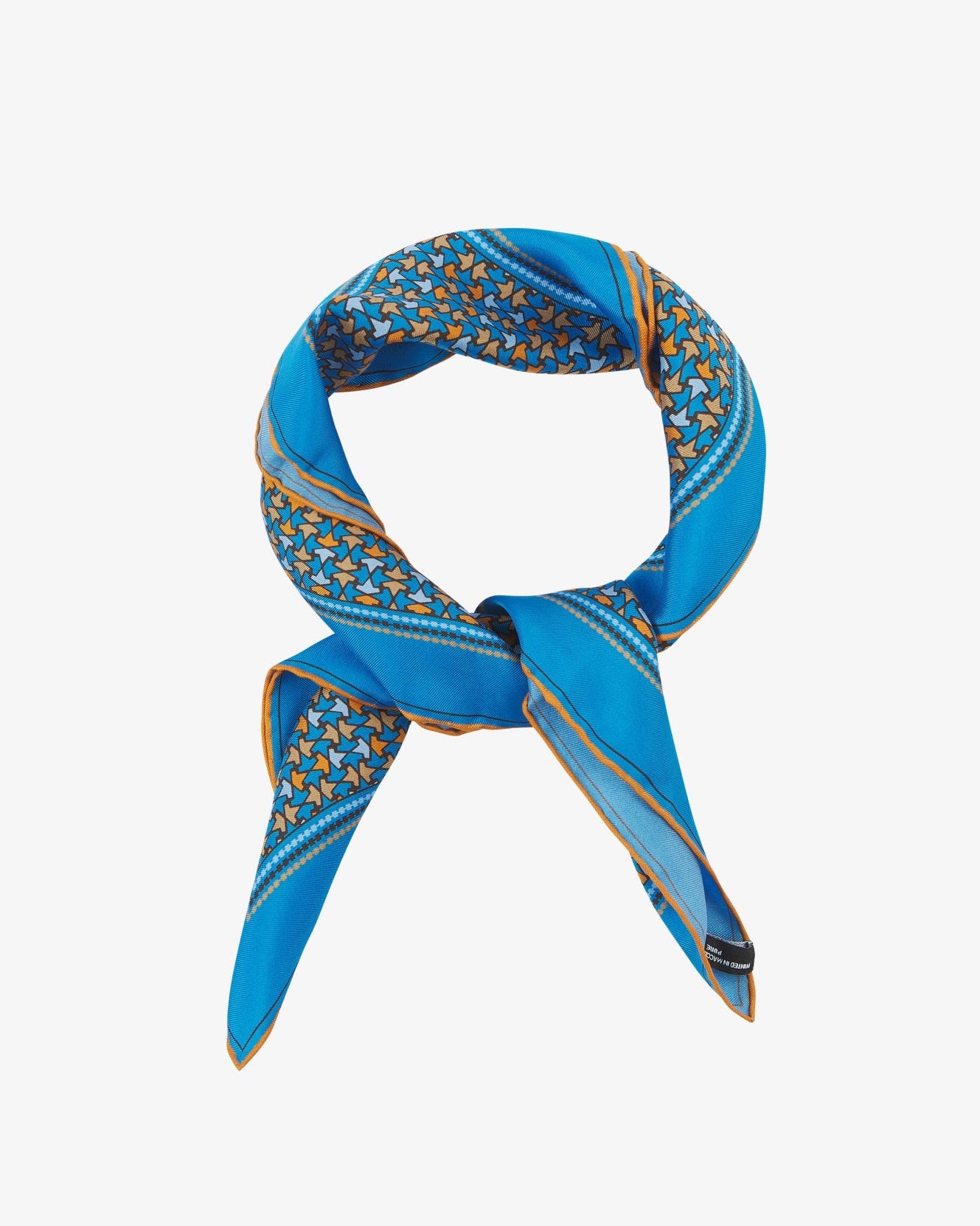 The 'Richmond' neckerchief looped and knotted, featuring vivid azure silk bordered with a tessellated leaf pattern in orange, gold, and sky blue.