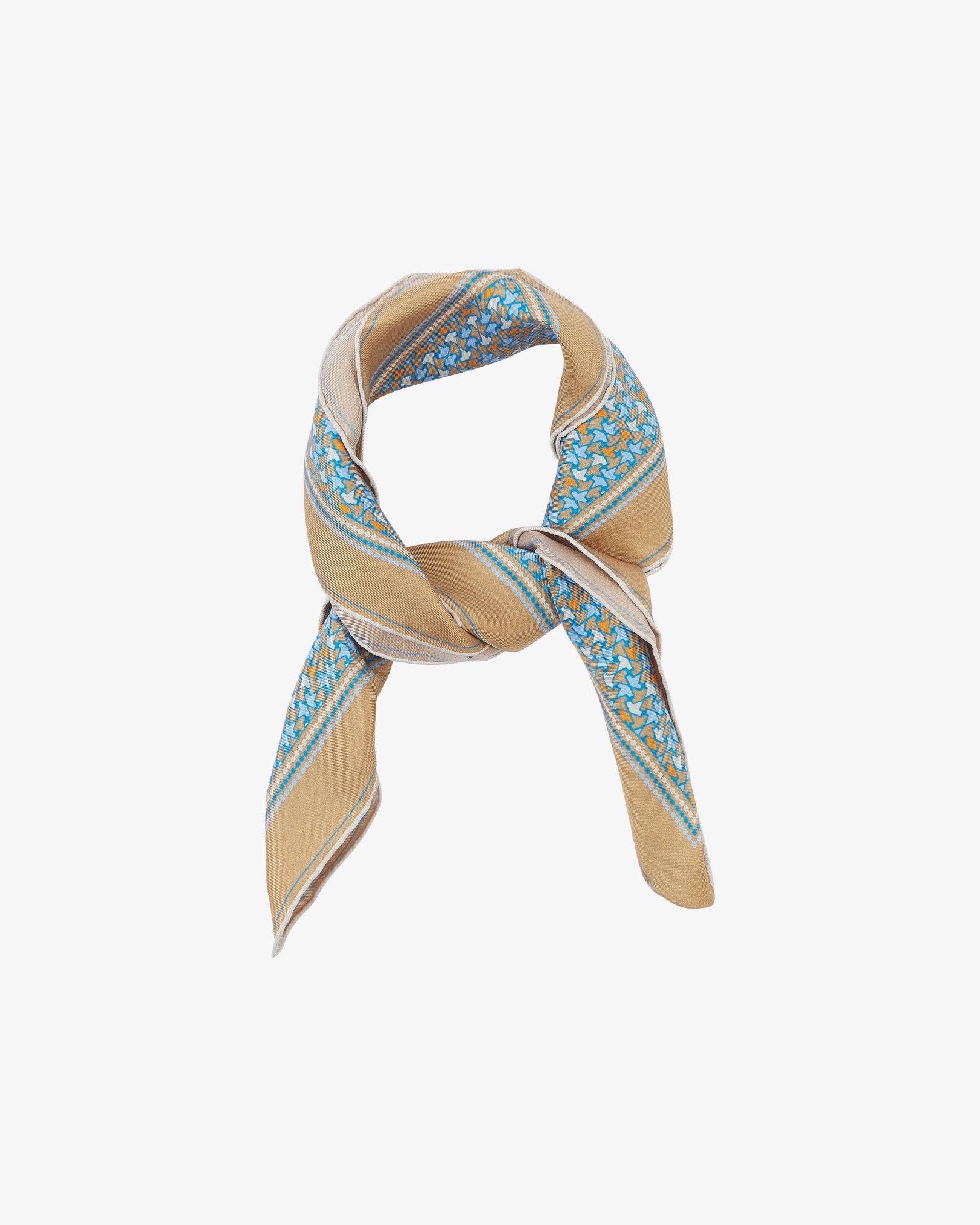 The 'Richmond' neckerchief looped and knotted, showcasing the golden-beige silk background with a delicate border of blue and orange leaf motifs.