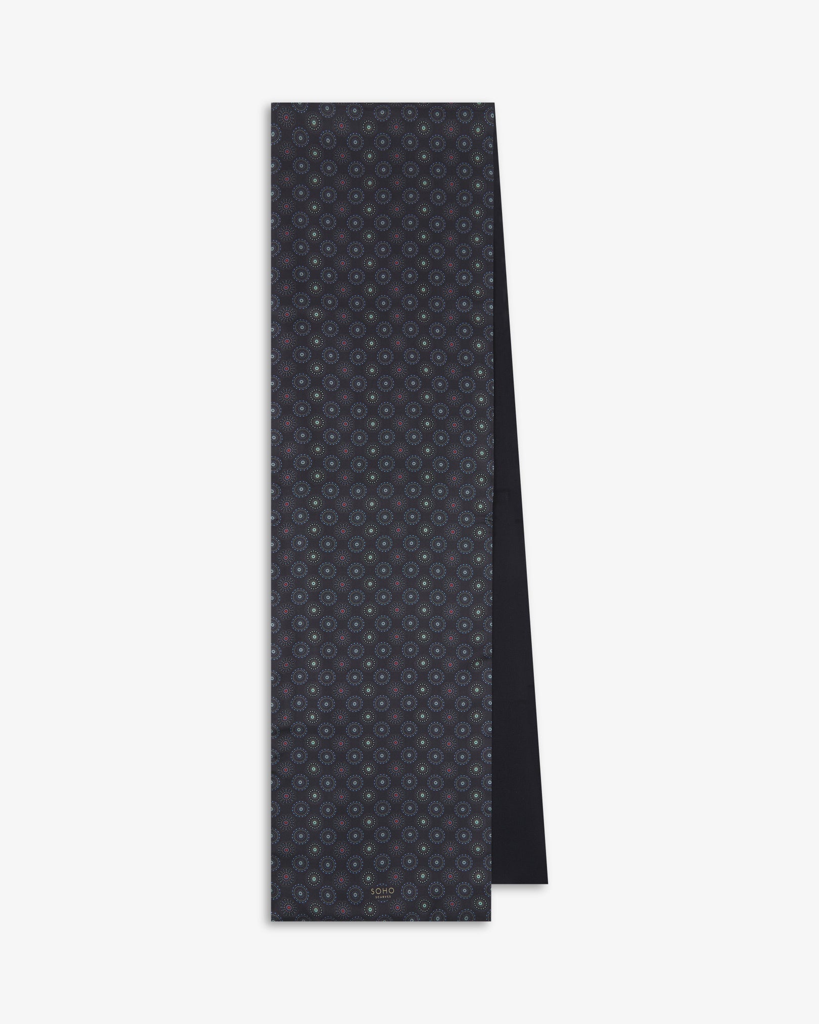 The Seattle 'Gardenia' dress scarf from SOHO Scarves, folded and presented vertically to show the full dimensions and repeating circular pattern in blue and mint green on a black background with subtle red accents.