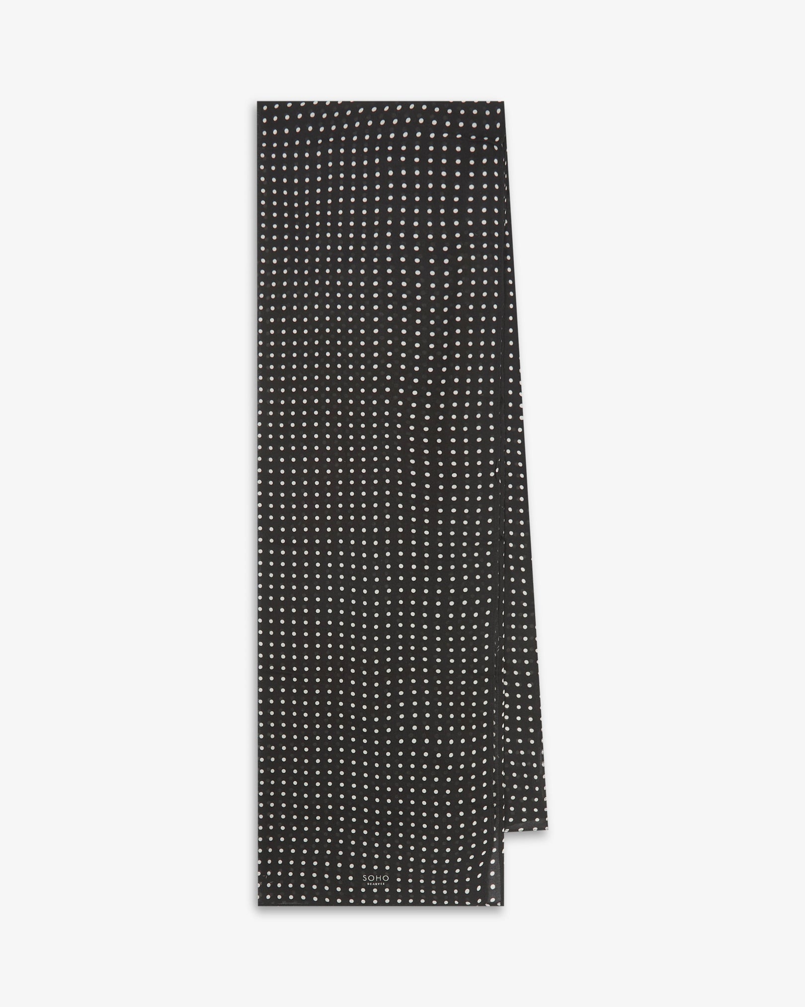 The Shinagawa bohemian wide scarf from SOHO Scarves folded and presented vertically to show the full dimensions and classic white polka dot pattern on a black background.