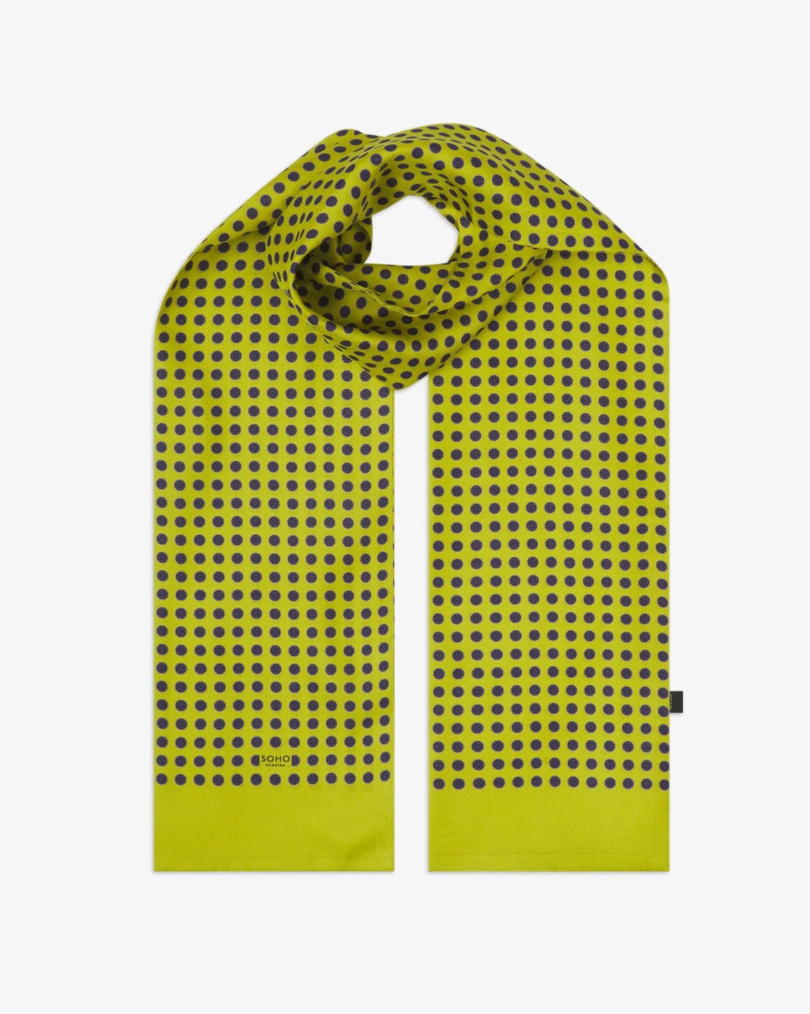 The 'Skytree Lime' silk scarf looped with both ends parallel to effectively display the dark disc pattern against the sheen of the fine silk material.