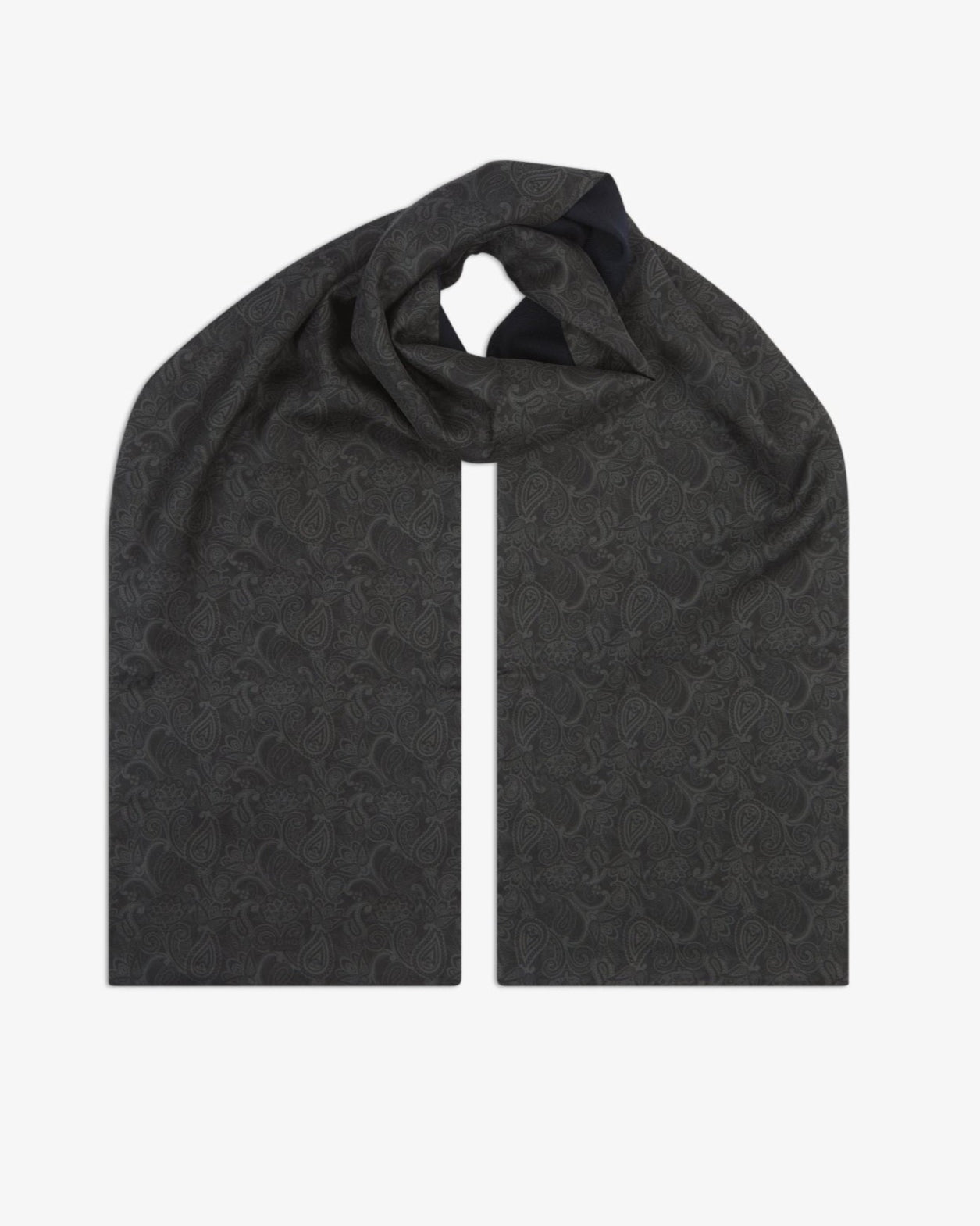 The 'Tonal Paisley' black wool-backed silk scarf, looped at the centre to show the full length and pattern of the charcoal paisley silk, with the soft black wool underside subtly visible.