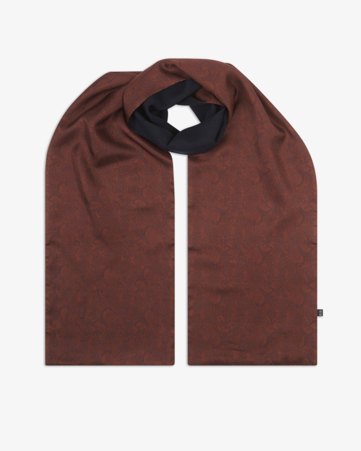 The 'Tonal Paisley' cocoa wool-backed silk scarf, looped at the centre to reveal the full length of the warm brown paisley silk design, with the dark wool underside subtly exposed near the knot.