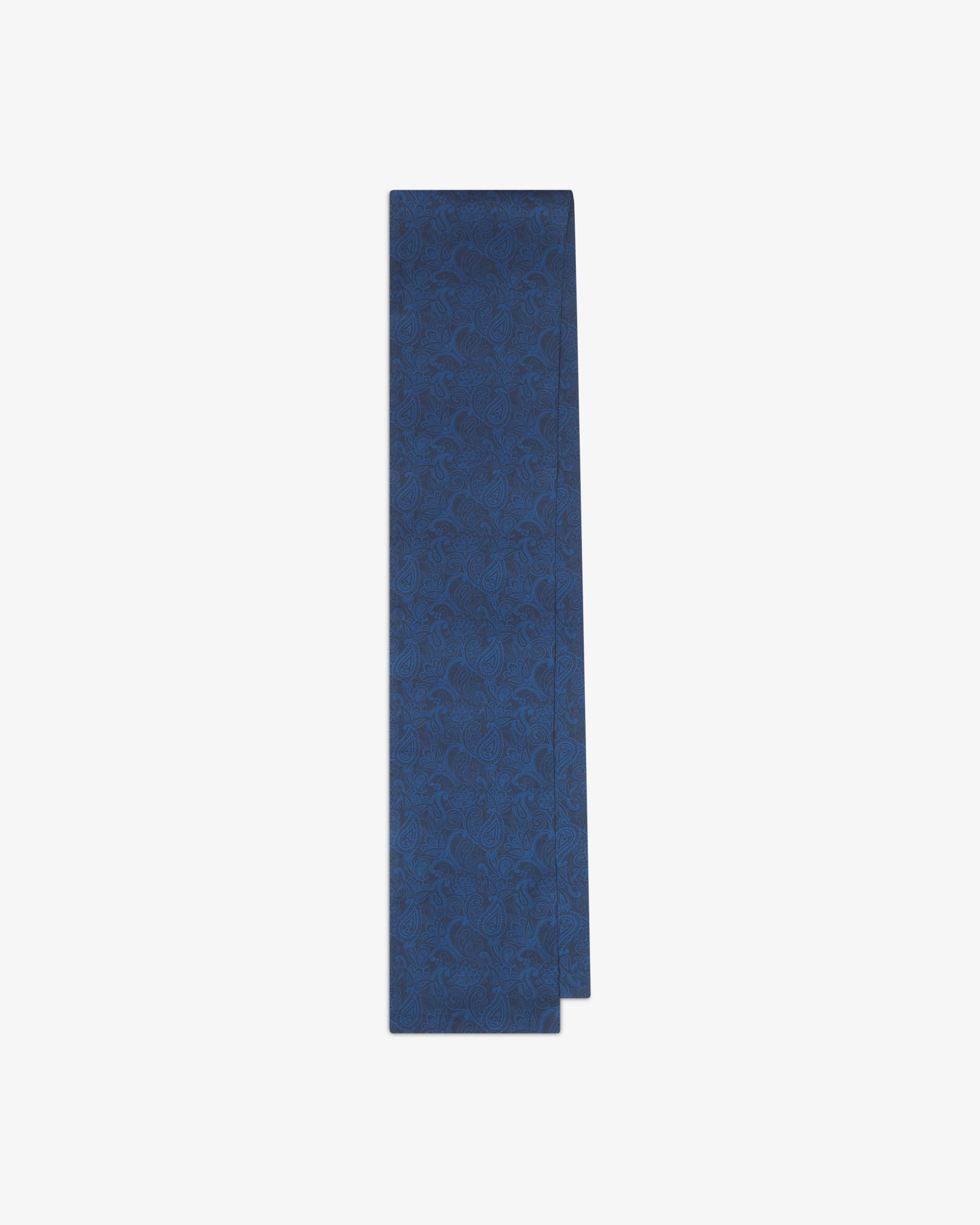 The 'Tonal Paisley' dark navy silk scarf folded and presented vertically to reveal the full scarf dimensions and deep blue paisley detailing throughout.