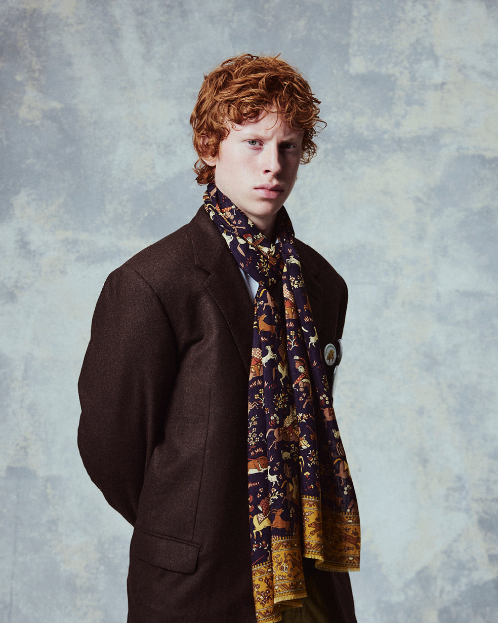 Top-half view of man wearing the English-made, 'Hunters in Indigo' silk and wool scarf from Soho Scarves.