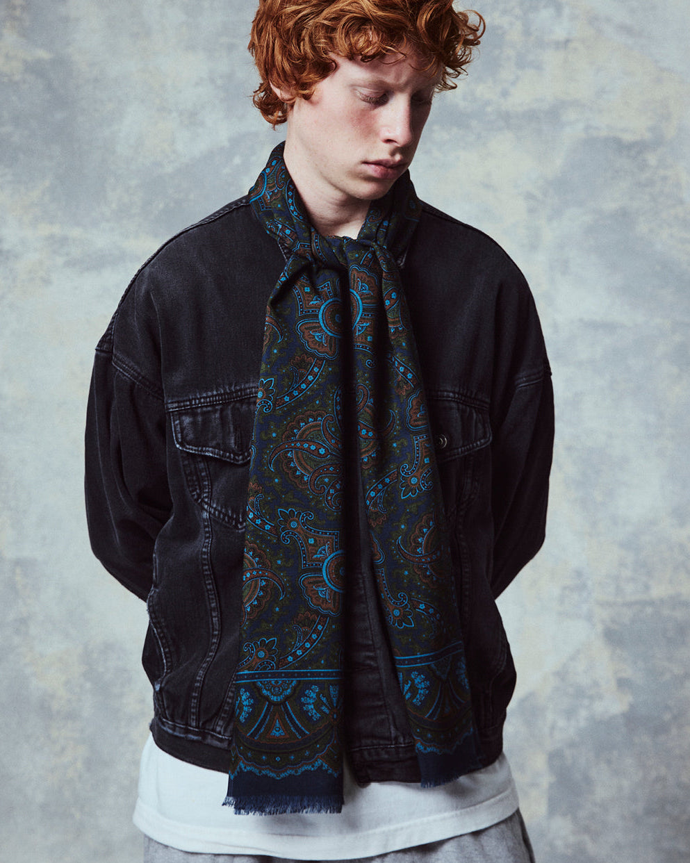 Top-half view of man wearing the English-made, 'Paisley in Navy' silk and wool scarf from Soho Scarves.