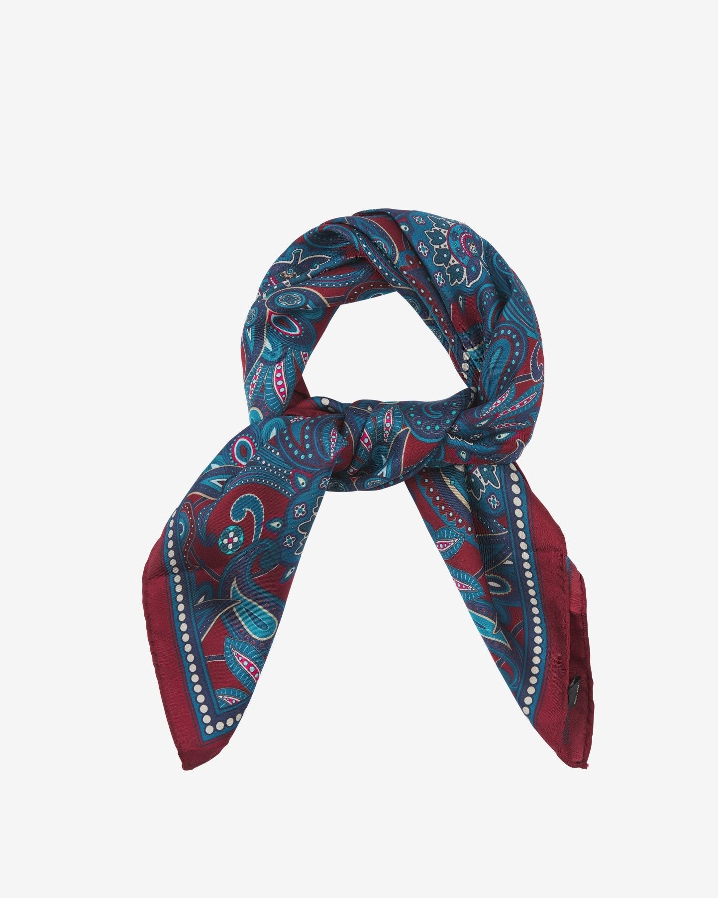 The 'Windermere' neckerchief looped and knotted, presenting the blue and blue-green paisley patterns against the sheen of the fine silk material.