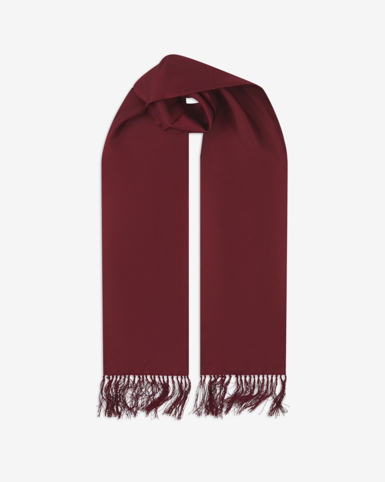 Wine-red silk aviator scarf from Soho Scarves. Looped with both ends parallel showing the branding label to the right and the matching 8cm long fringes.