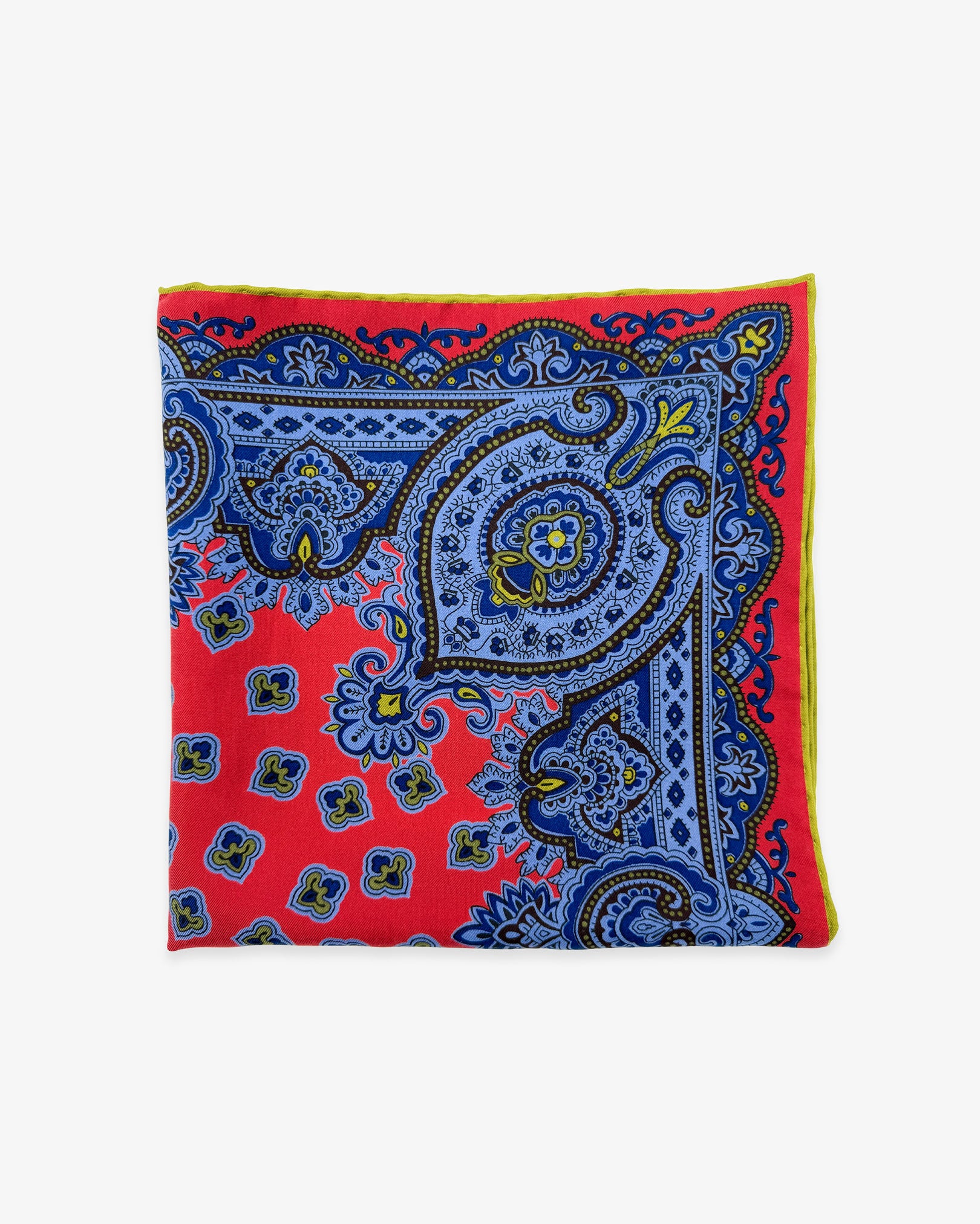 The 'Aldborough' pocket square from SOHO Scarves Madder silk collection. Folded into a quarter, showing the various traditional stylised forms in blue and red.