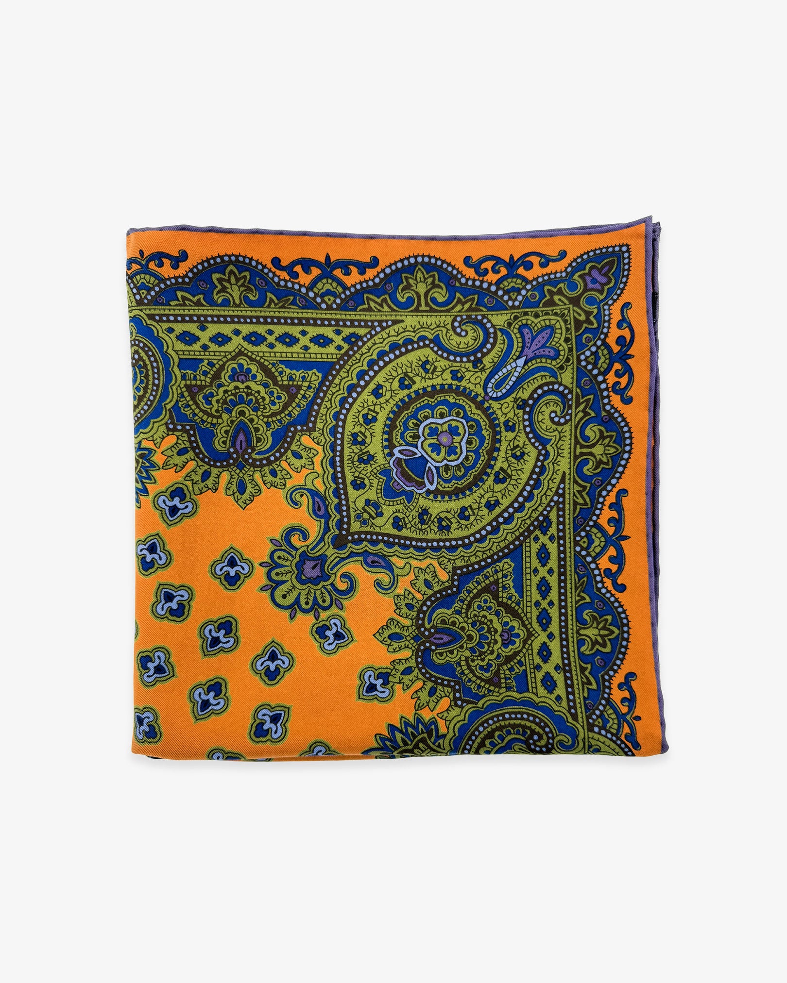 The 'Ambleside' pocket square from SOHO Scarves Madder silk collection. Folded into a quarter, showing the various traditional stylised forms in orange, green and blue.