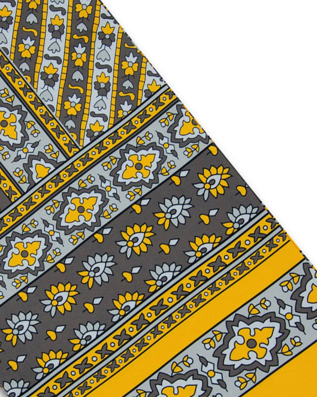 Angled view of the patterned silk and wool wide scarf, presenting a closer view of the decorative and floral-inspired patterns in yellow, grey and silver.