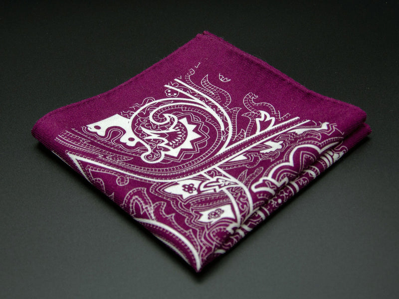 Pure wool 'Kadriorg' burgundy pocket square folded into a quarter, clearly showing the large white swirling paisley motif.