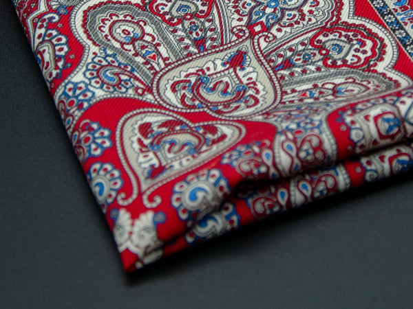 Close-up of a quarter point of the 'Pegulin' pocket square, providing clear view of the wool weave and an even closer look at a paisley segment.