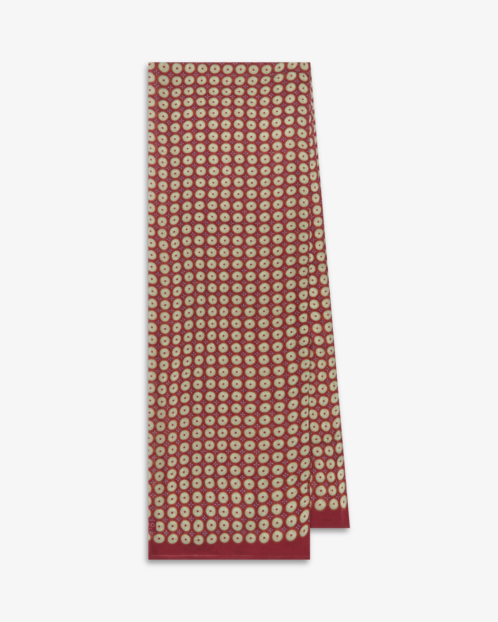 The Bellingham 'Gardenia' bohemian wide scarf folded and presented vertically to show the full dimensions and repeating concentric circular pattern in green, gold, orange and blue on a rich maroon background.