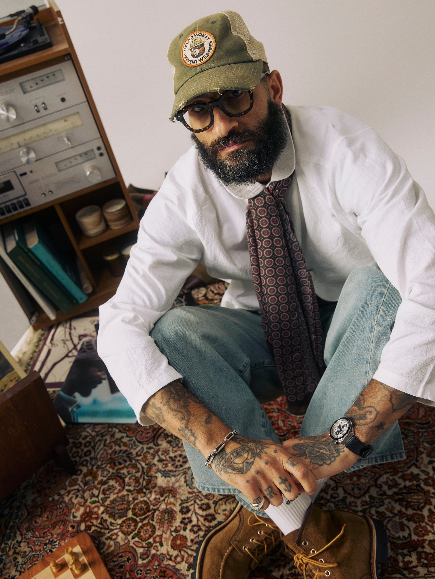 Model sitting cross-legged wearing the 'Mahogany Daze' Bellingham Bohemian Lightweight Wide Scarf from SOHO Scarves.