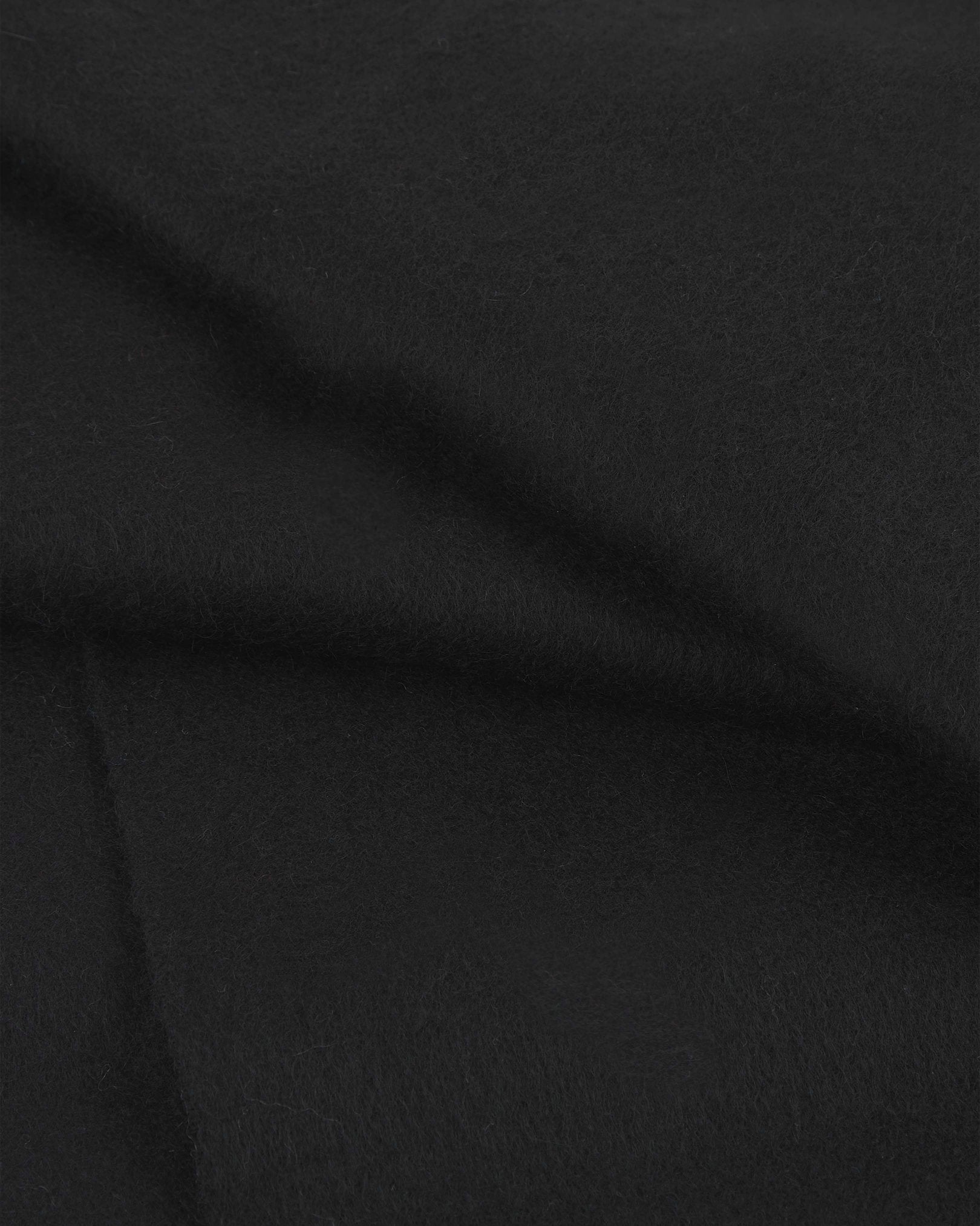 Close range view of black cashmere scarf from Soho Scarves, showing individual fibres and texture of the luxurious material.