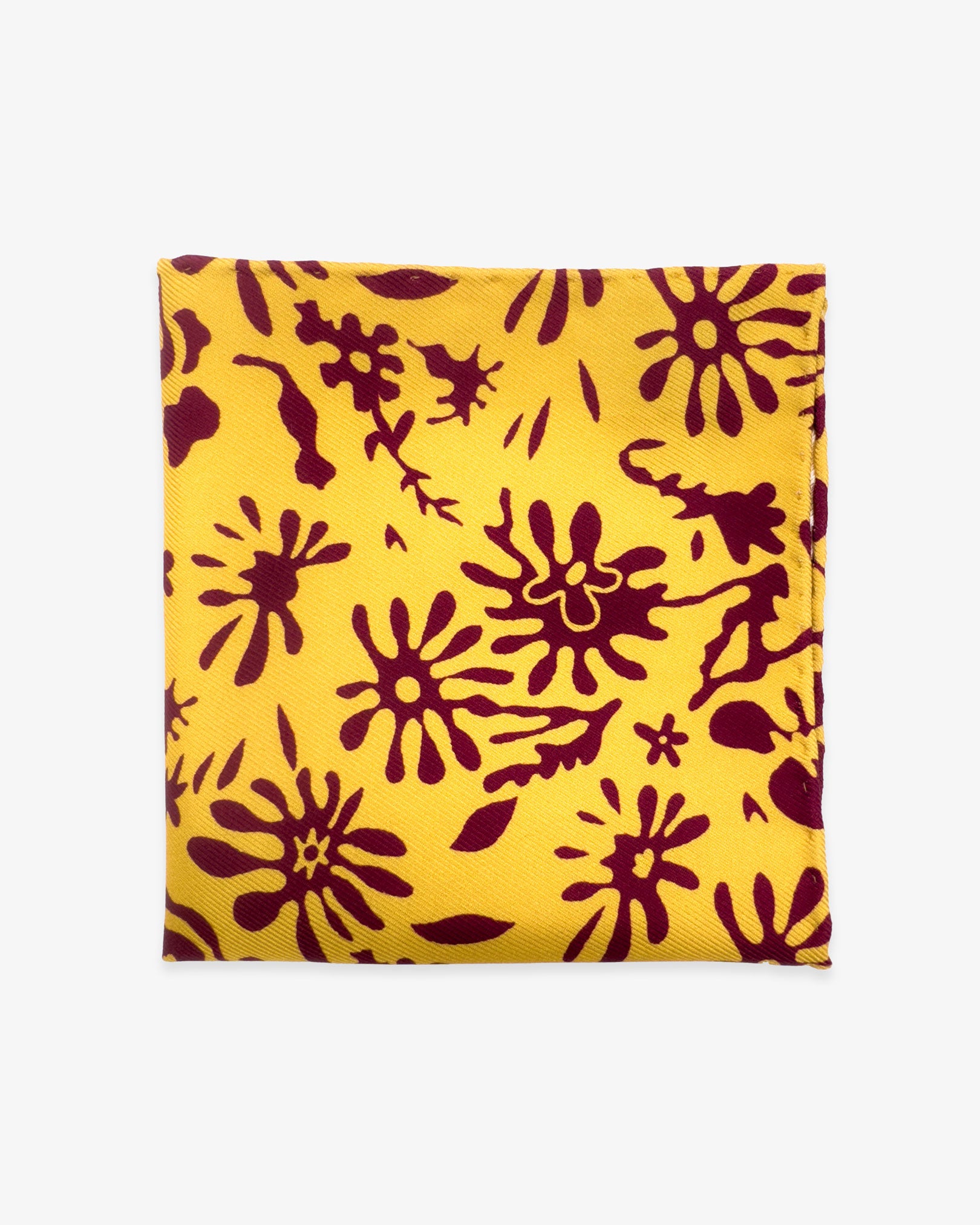 The 'Blenheim' silk pocket square from SOHO Scarves UK collection. Folded into a quarter, showing the organic maroon patterns against a bright yellow ground.