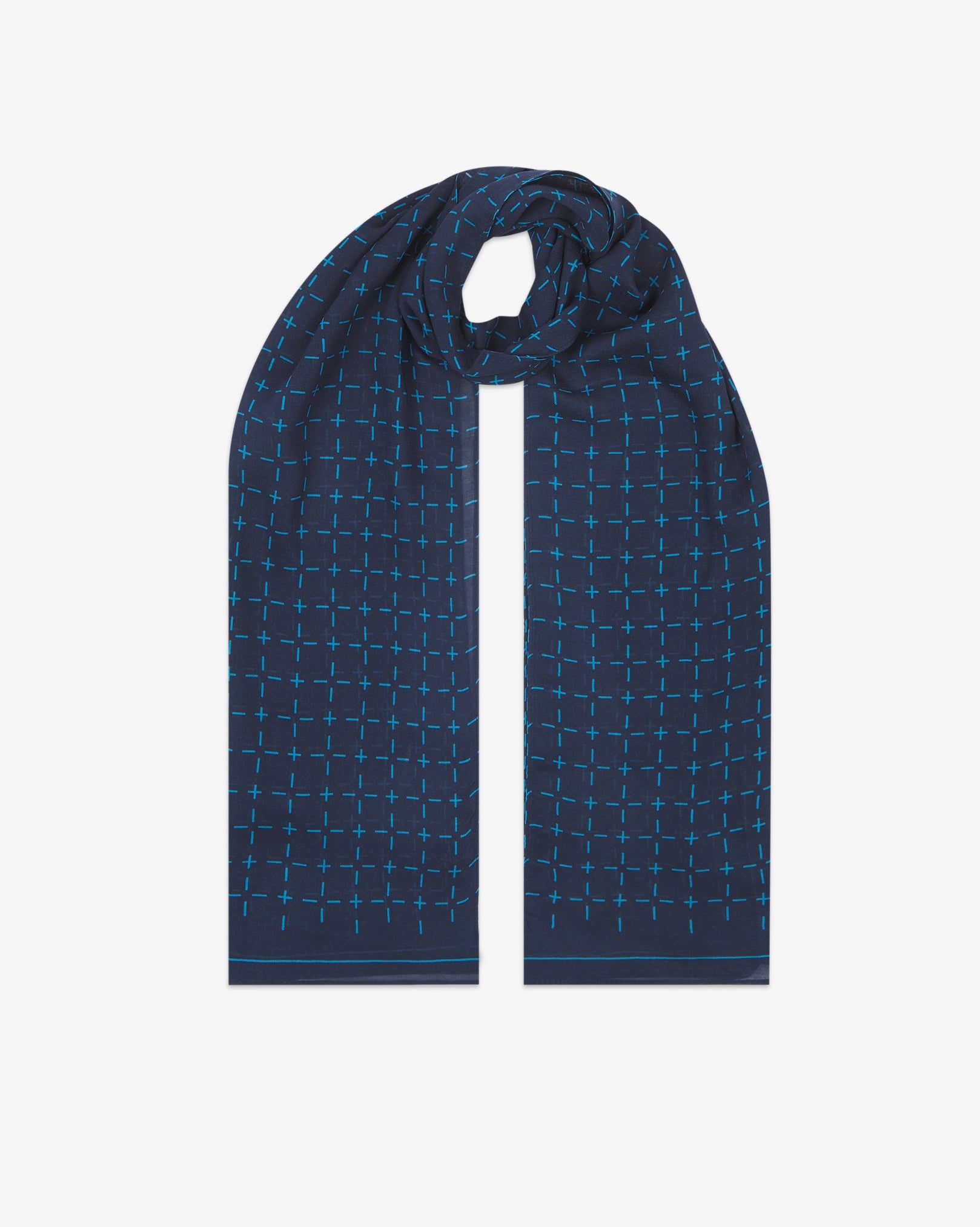 The 'Crosses' blue bohemian wide scarf looped with both ends parallel, showcasing a neat geometric grid of light blue dashes and crosses on a navy blue background across the soft modal and wool blend fabric.