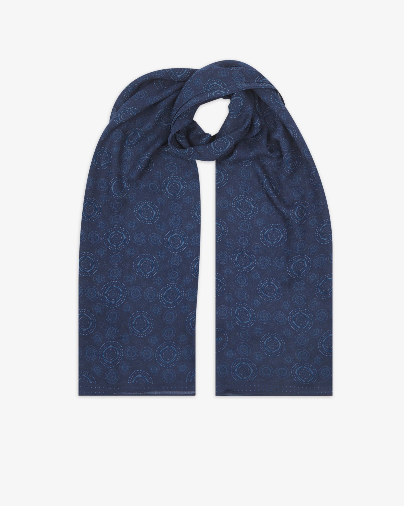 The 'Circles' blue bohemian wide scarf looped with both ends parallel, showcasing concentric Op art-inspired disc motifs in light blue on a dark blue background across the soft modal and wool blend fabric.