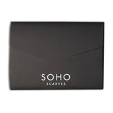 Opened black packaging for aviator scarf from Soho Scarves, containing style manifesto.