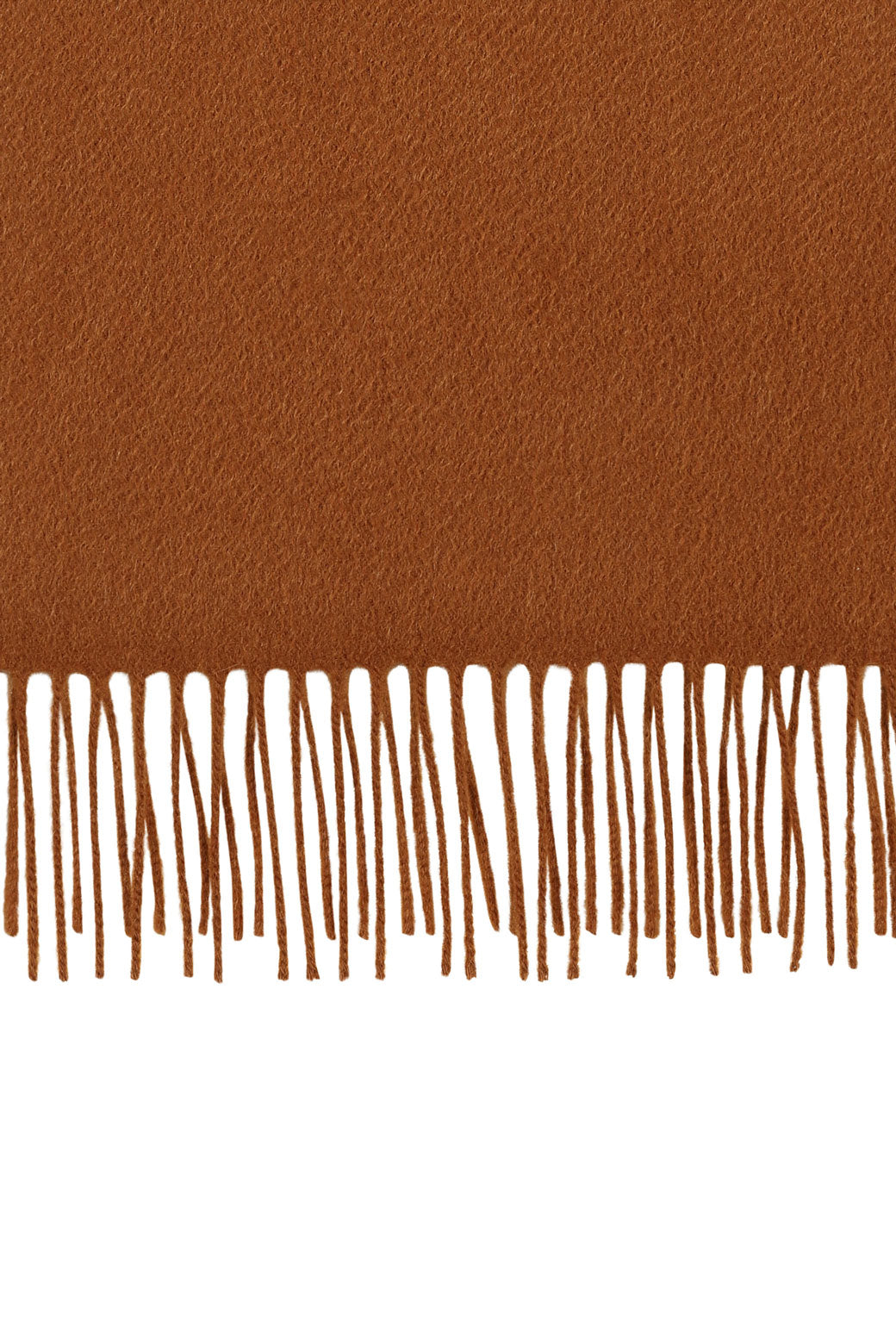 Perfectly horizontal view of the fringe of a camel pure cashmere scarf from Soho Scarves against a white background.
