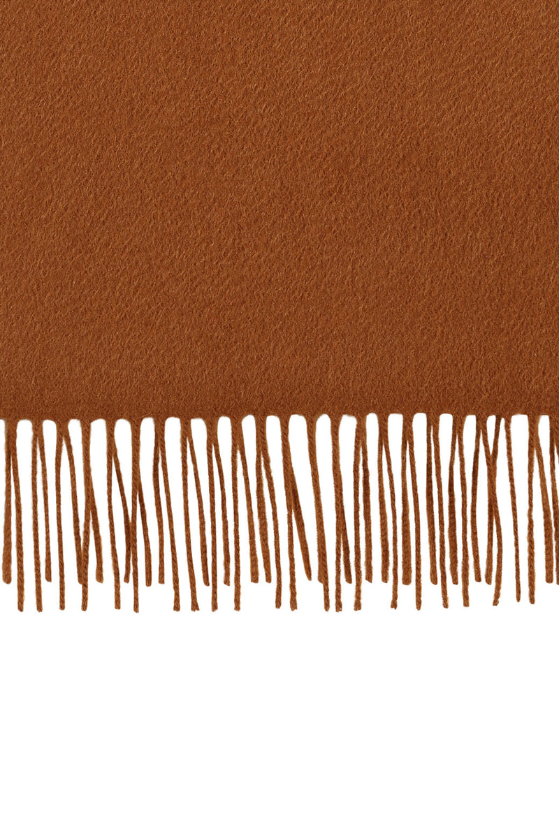 Perfectly horizontal view of the fringe of a camel pure cashmere scarf from Soho Scarves against a white background.