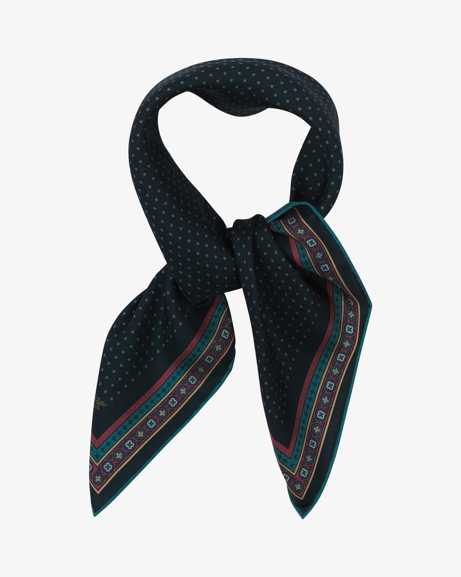 The 'Chiswick' neckerchief looped and knotted, revealing a fine teal micro-dot diamond lattice on a deep midnight indigo silk ground, finished with a berry-red and teal geometric medallion border and a subtle silk lustre.