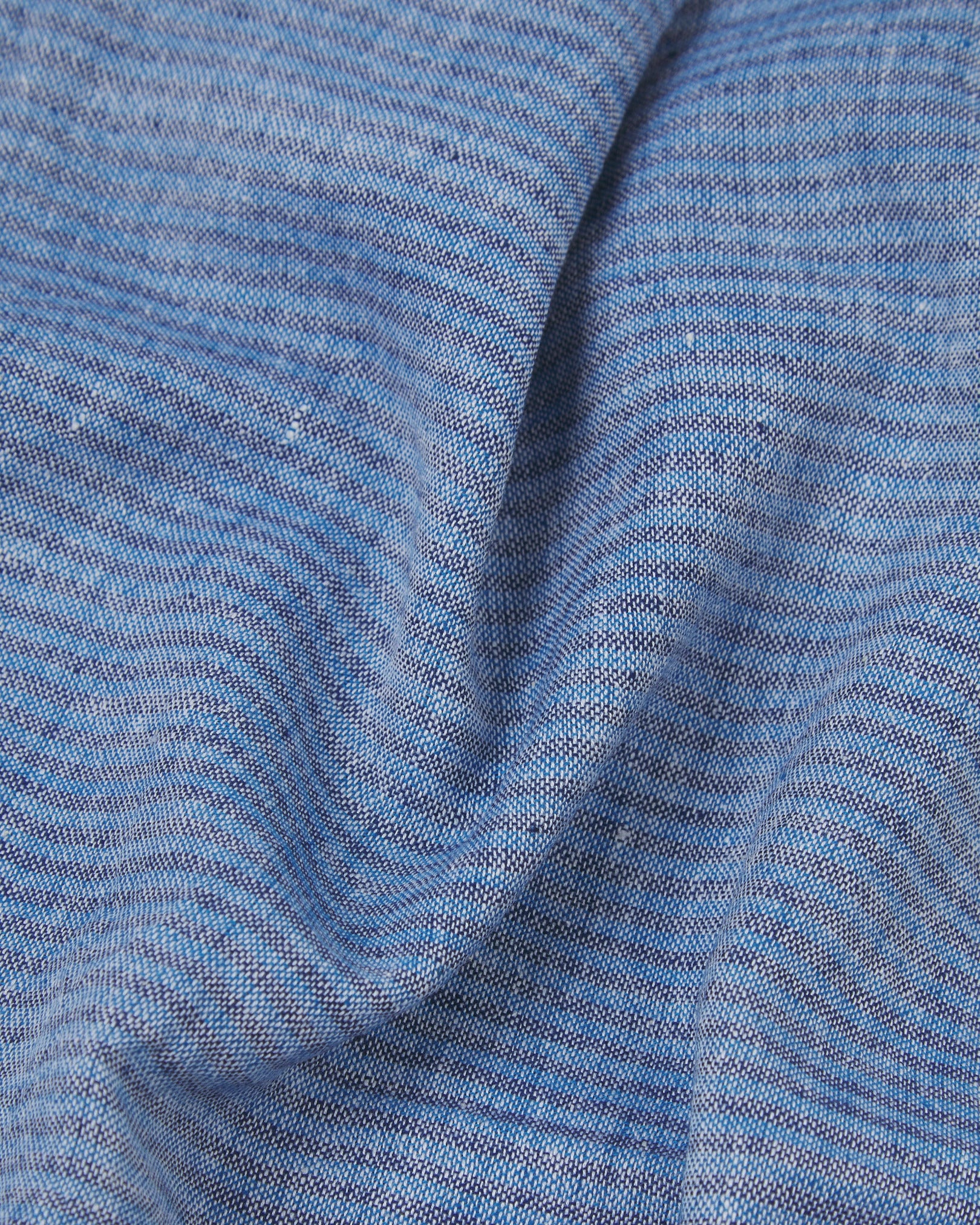 Ruffled close-up view of the UK-made, pure cotton 'MacArthur' scarf, presenting a closer view of the navy, white and blue yarns which make up the marled blue and pinstripe effect.