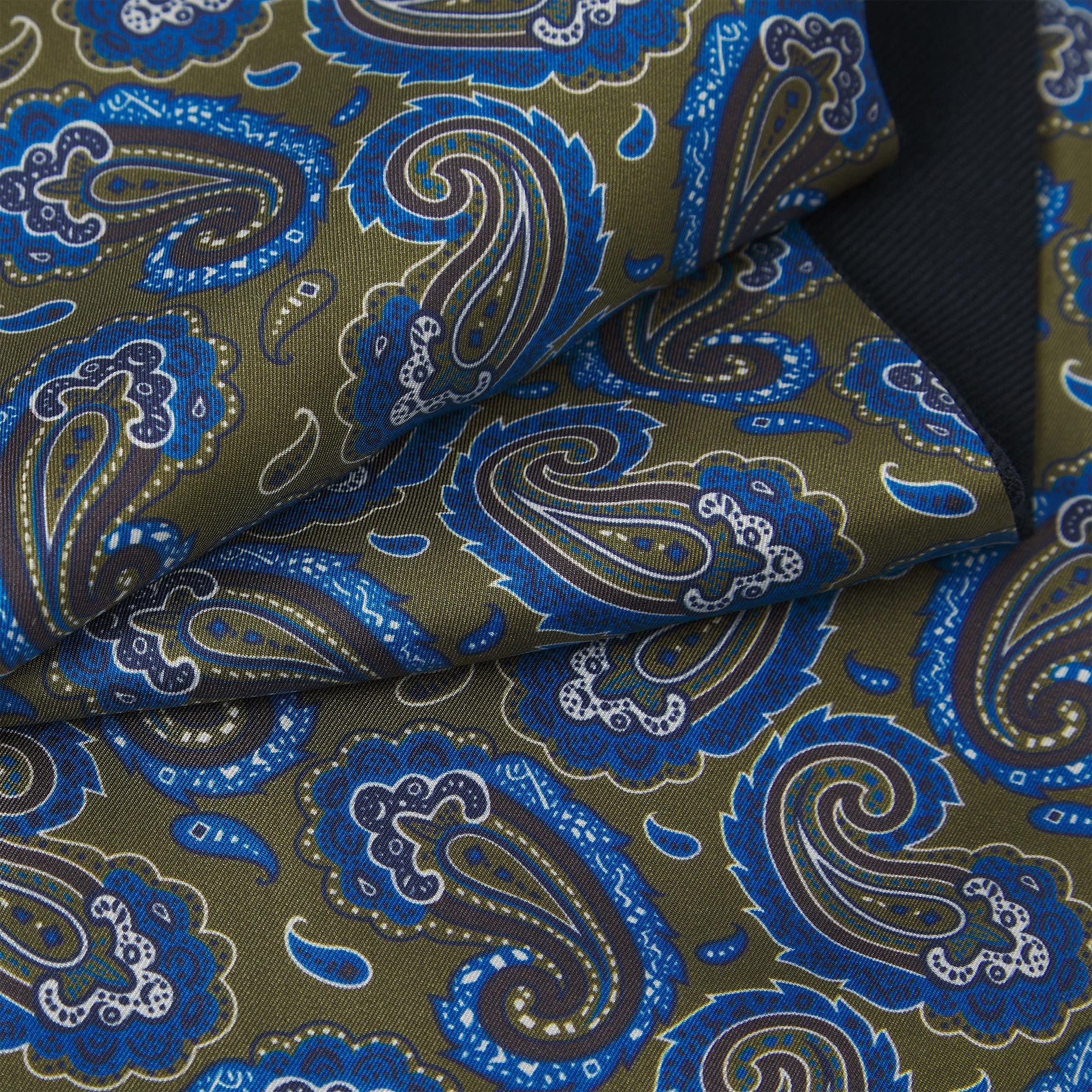 Ruffled close-up view of the Malibu silk scarf, presenting a closer view of the ornate green and blue paisley patterns.