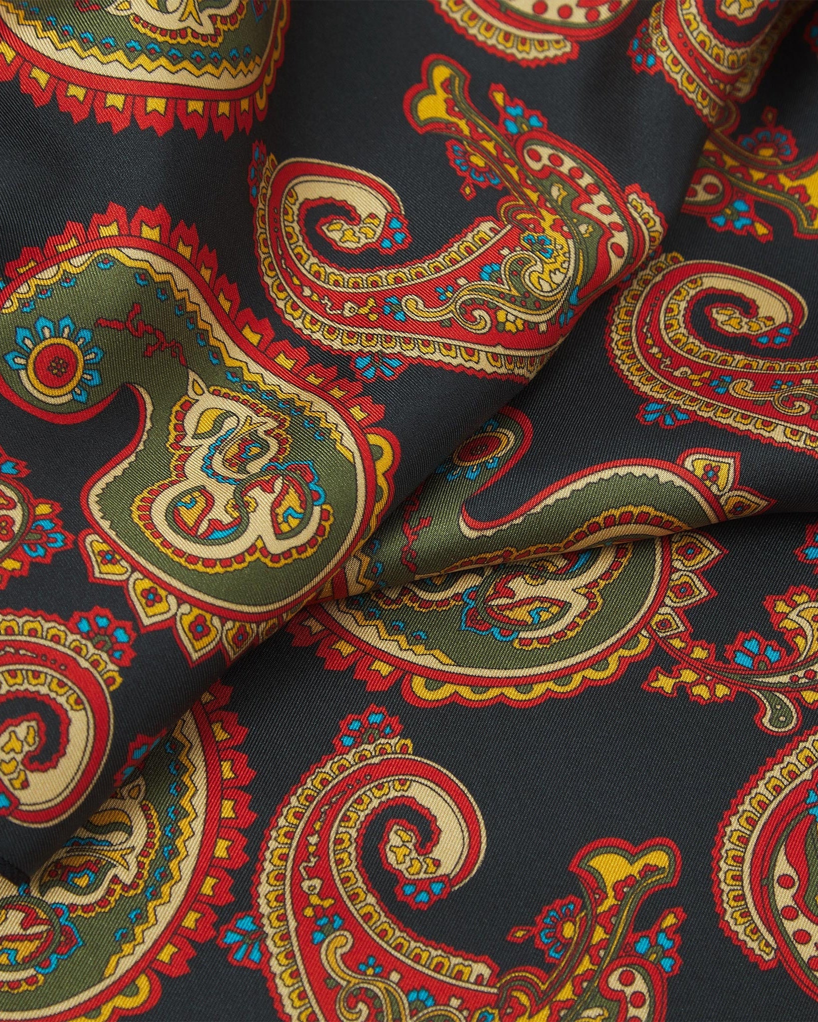 Ruffled close-up view of the Portland silk scarf, presenting a closer view of the ornate multi-coloured paisley patterns.