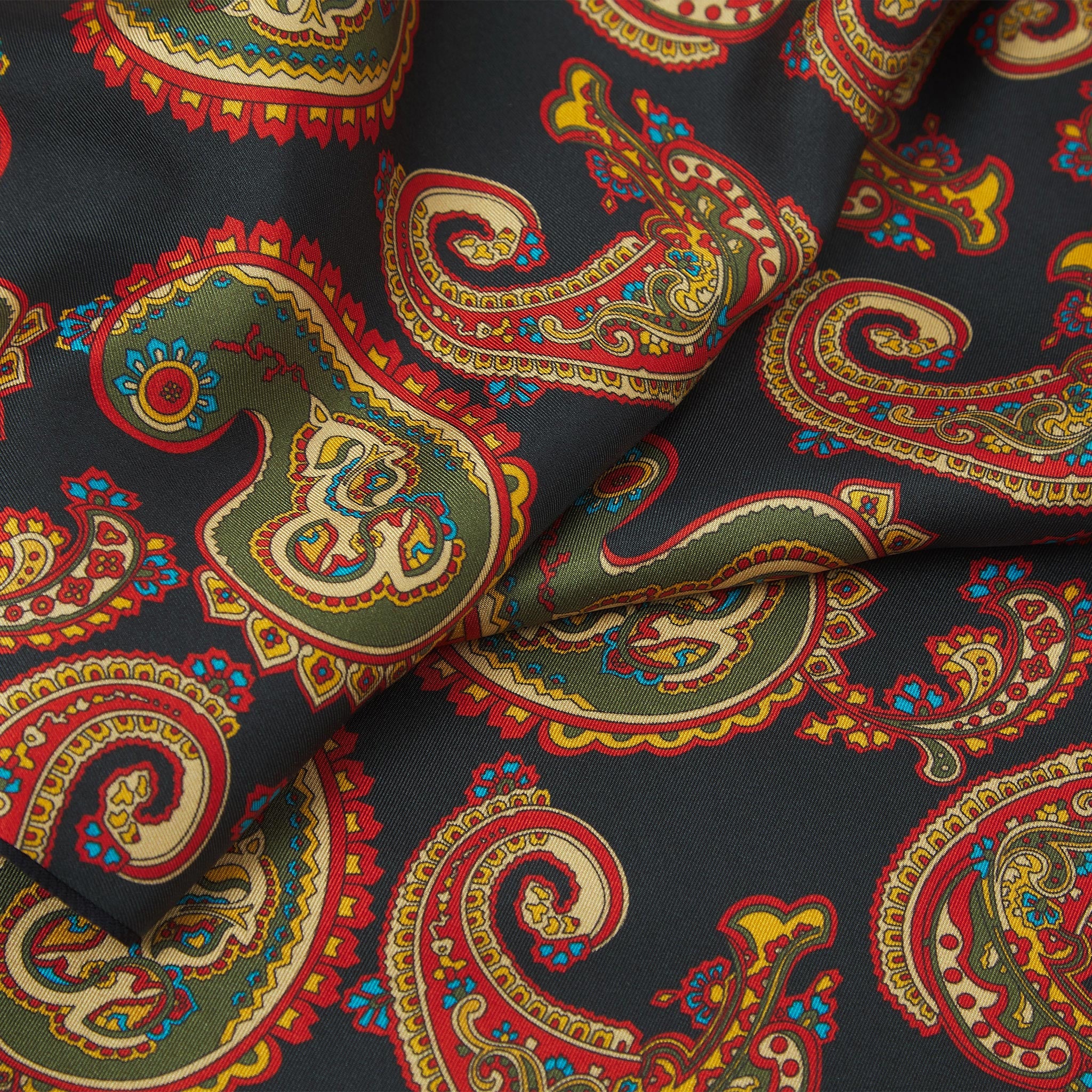 Ruffled close-up view of the Portland silk scarf, presenting a closer view of the ornate multi-coloured paisley patterns.